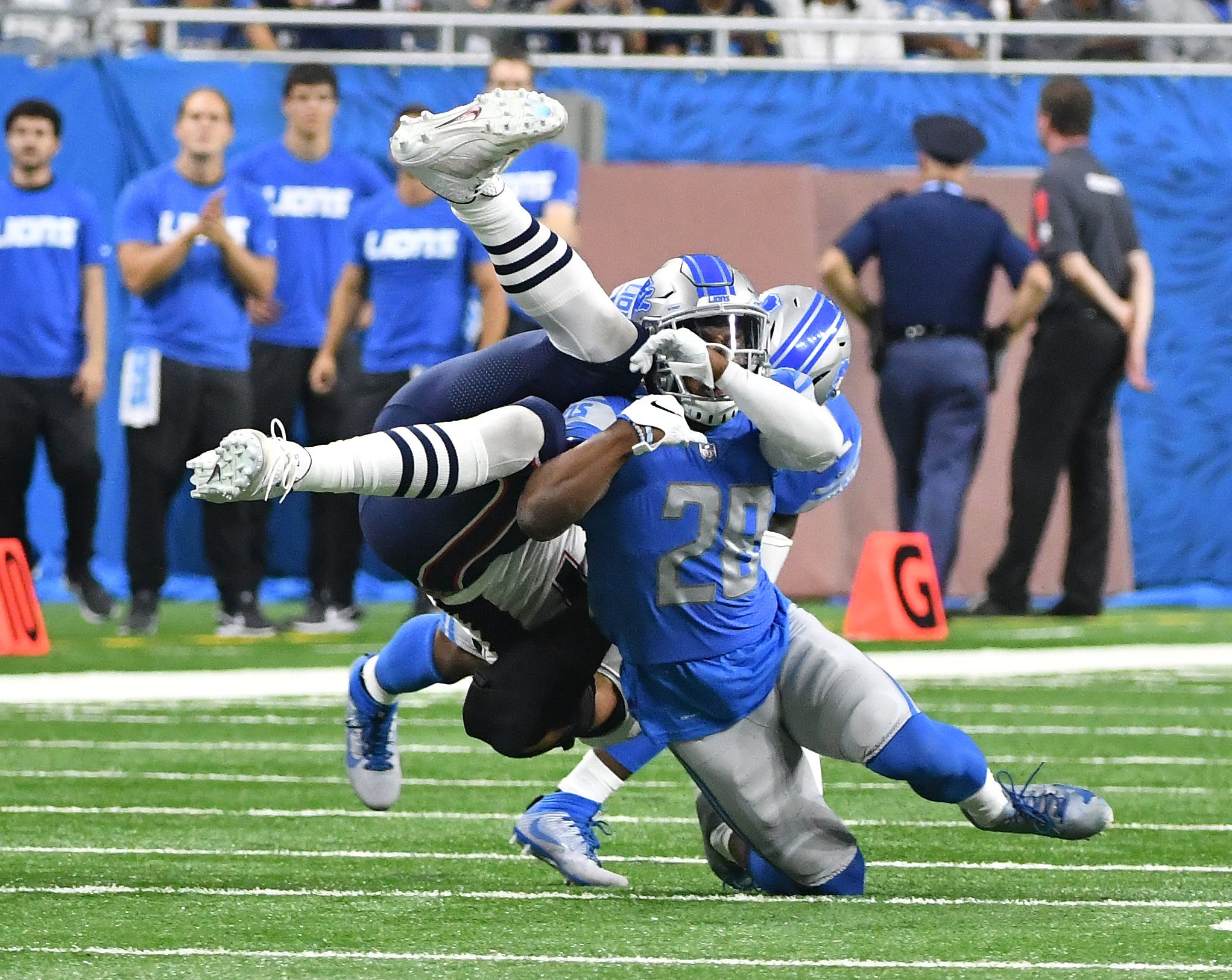 Lions Quandre Diggs and Tavon Wilson bring down Patriots ' Rob Gronkowski after a reception in the second quarter.