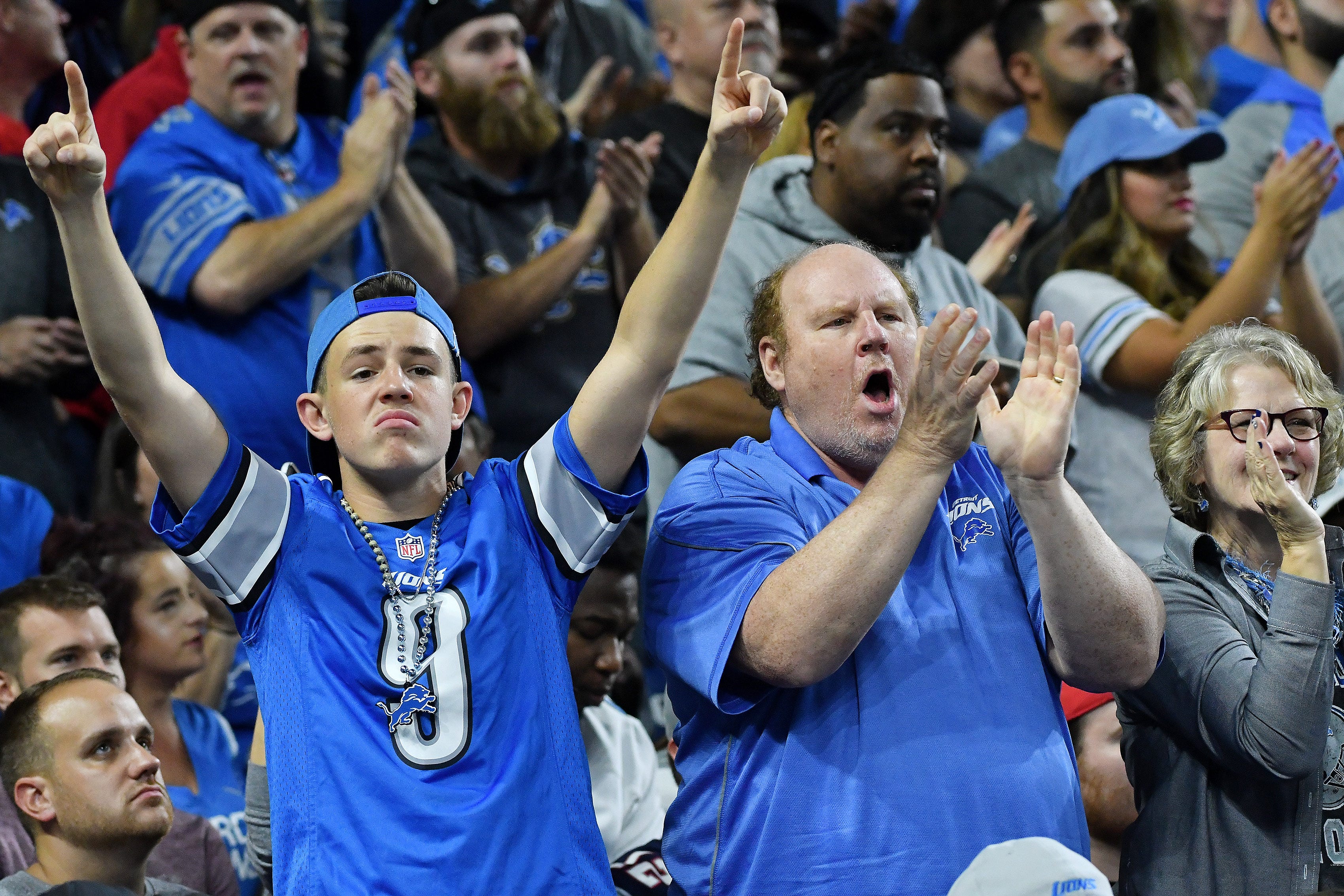Lions fans cheer after the play in the second quarter is ruled a touchdown after review.