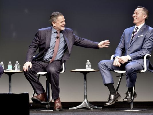 Dan Gilbert, left, and Christopher Ilitch share a laugh at a Detroit forum in May.