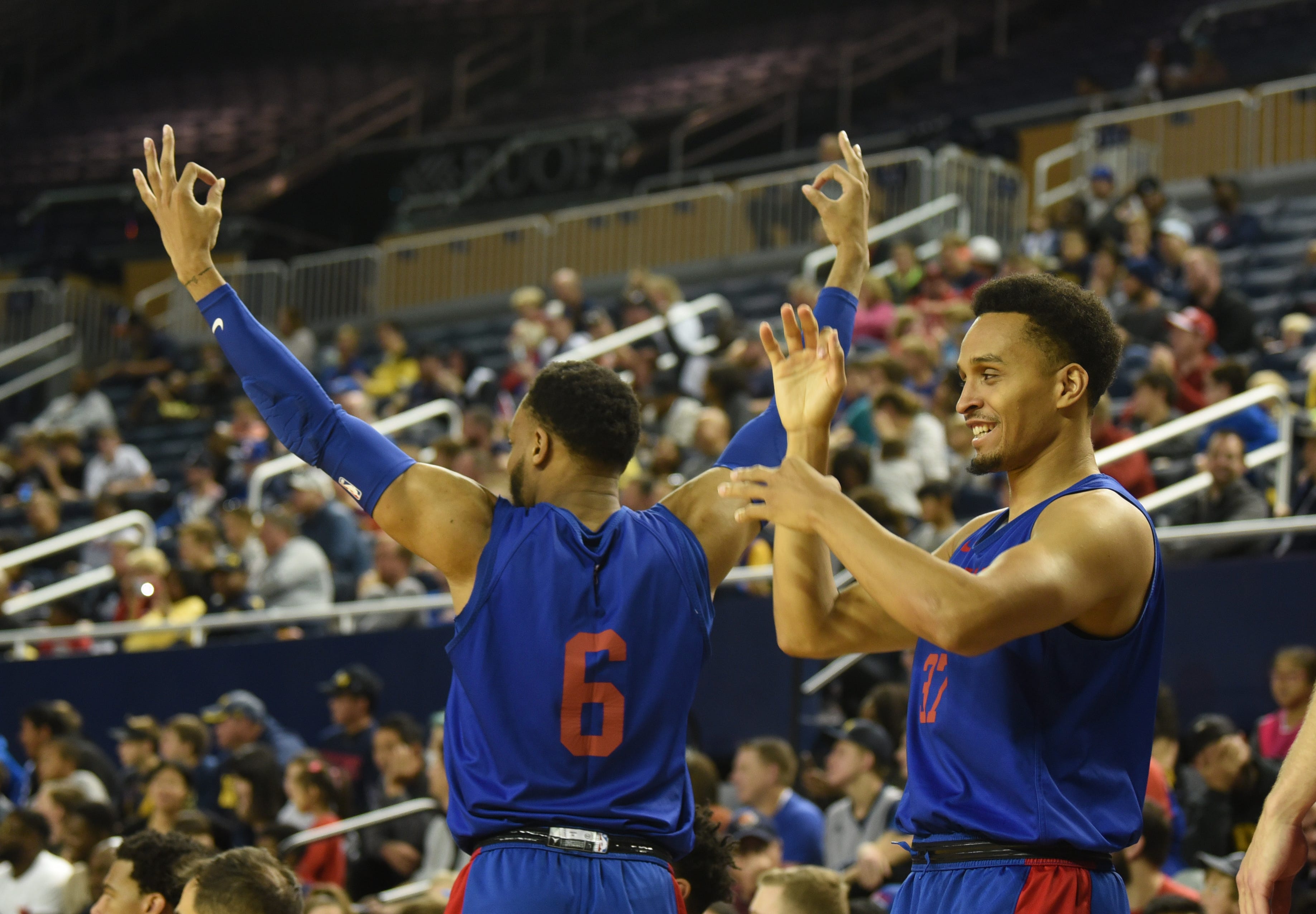 Pistons Bruce Brown, left, and Reggie Hearn react to a 3-point shot during open practice.