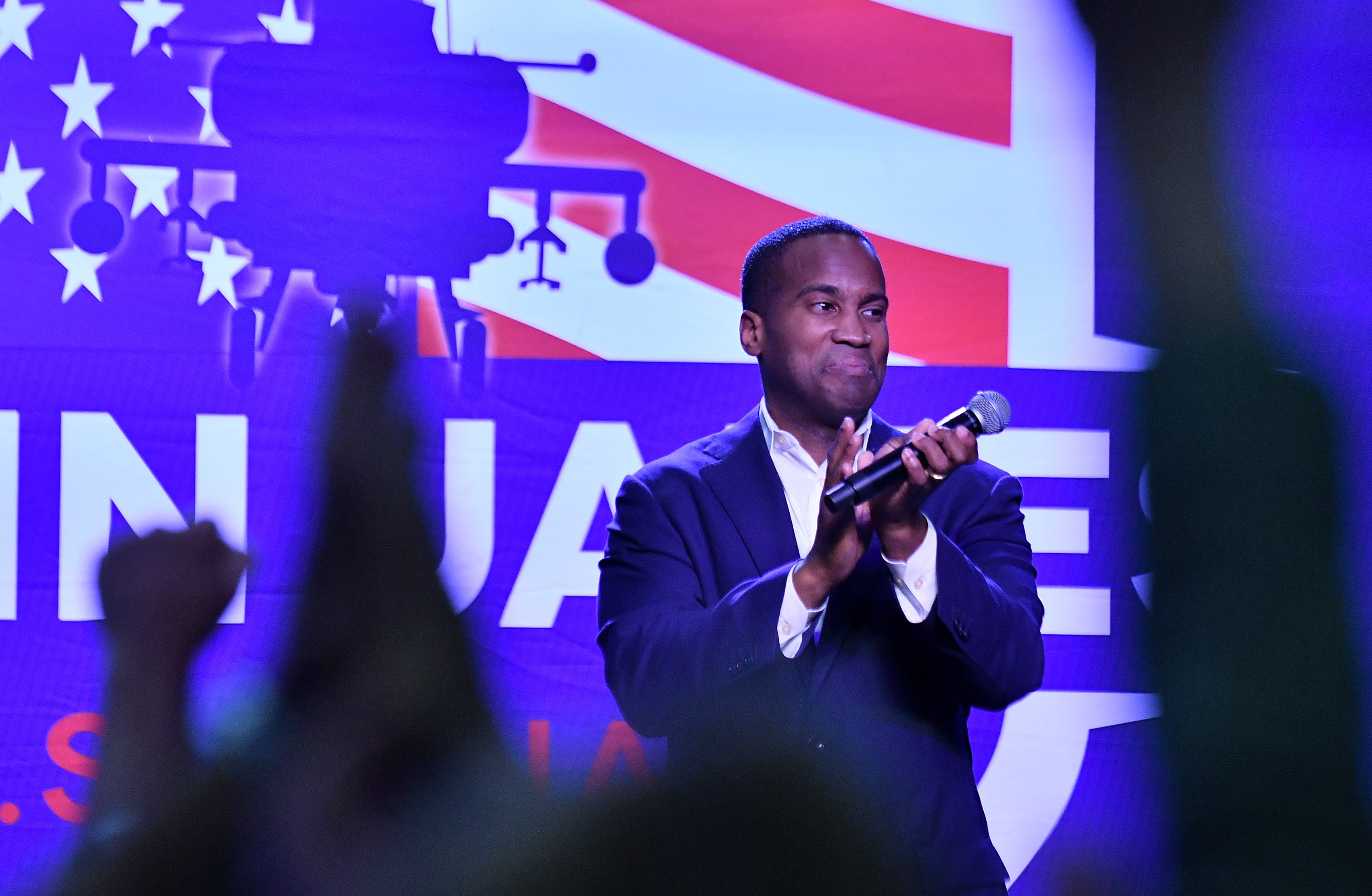 John James applauds his supporters during the rally.