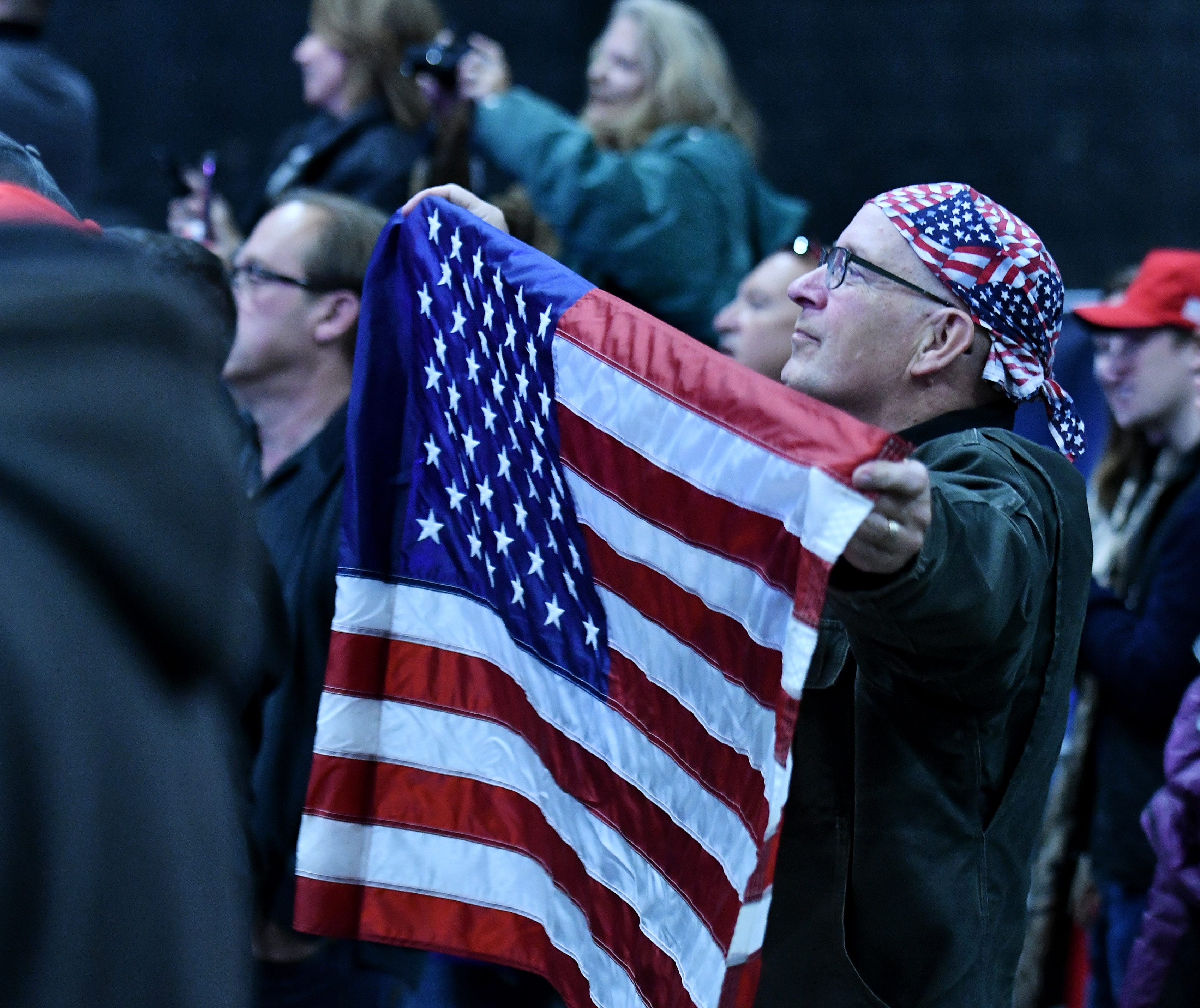 Mark Jaruzel of Mayville, Mich. holds up a large flag during the rally.    "Protect The American Dream Rally" for Republican candidate for U.S. Senate John James at the Flagstar Strand Theatre in Pontiac, Mich. on Oct 17, 2018. 
(Robin Buckson / The Detroit News)