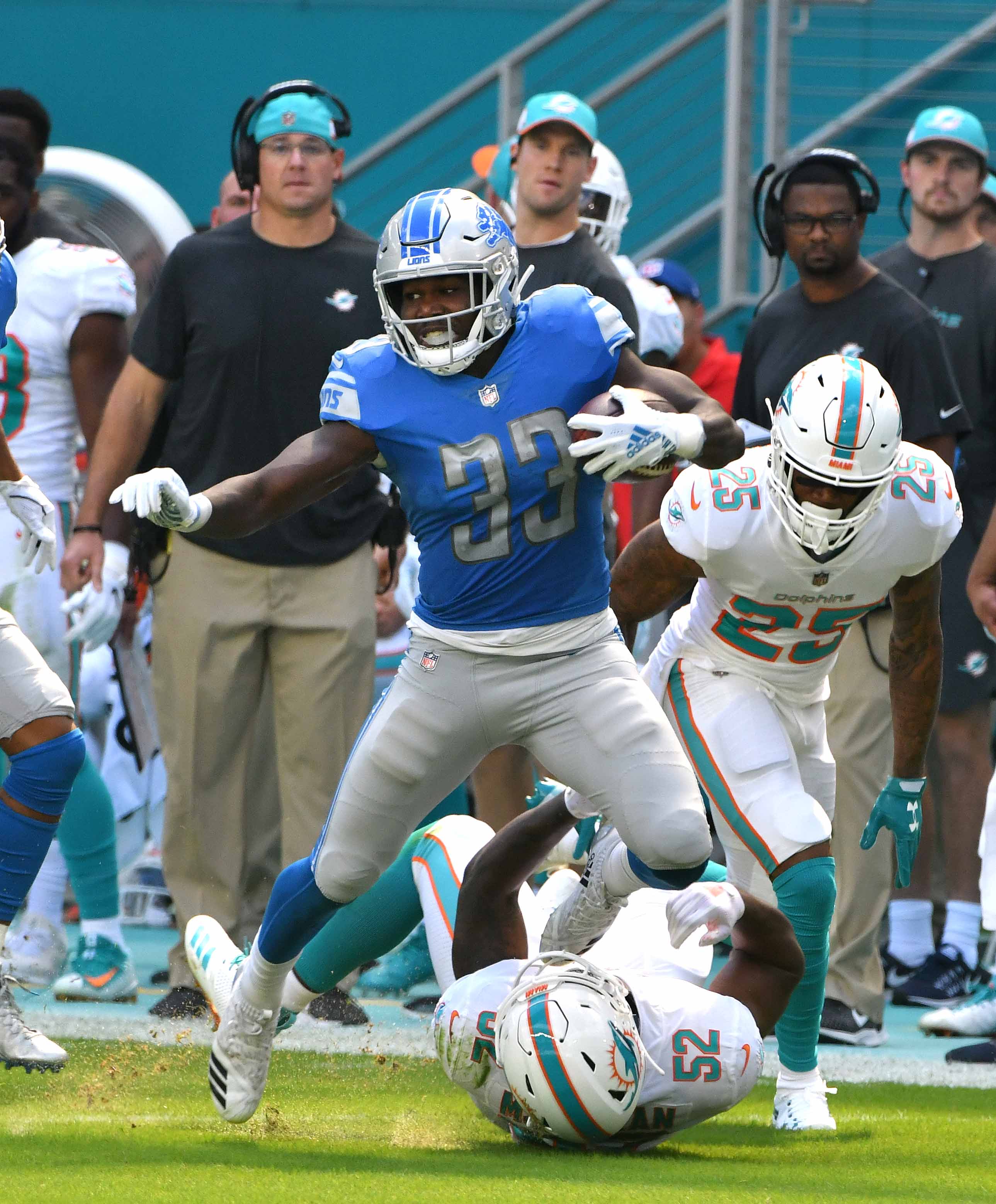 Lions running back Kerryon Johnson runs for a long first down past a pair of Dolphins defenders in the first quarter of Sunday's win in Miami.