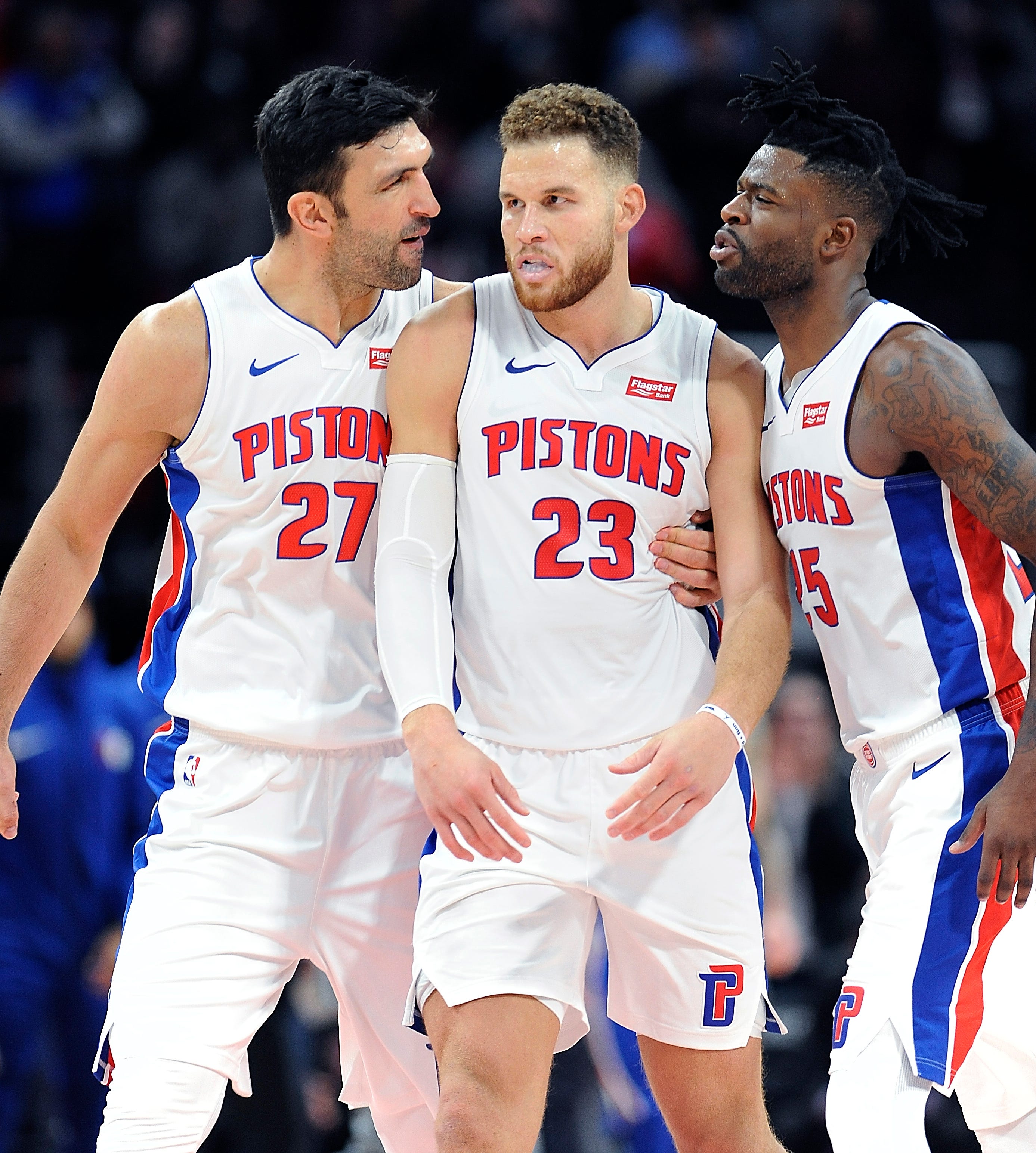 The Pistons' Zaza Pachulia and Reggie Bullock celebrate with Blake Griffin after he completed a three-point play to give the Pistons a one-point lead with 1.8 second left in the game. Griffin had a career high 50 points, The Pistons defeated the 76ers 133-132 in OT, Tuesday, October 23, 2018 at Little Caesars Arena in Detroit, Michigan.
