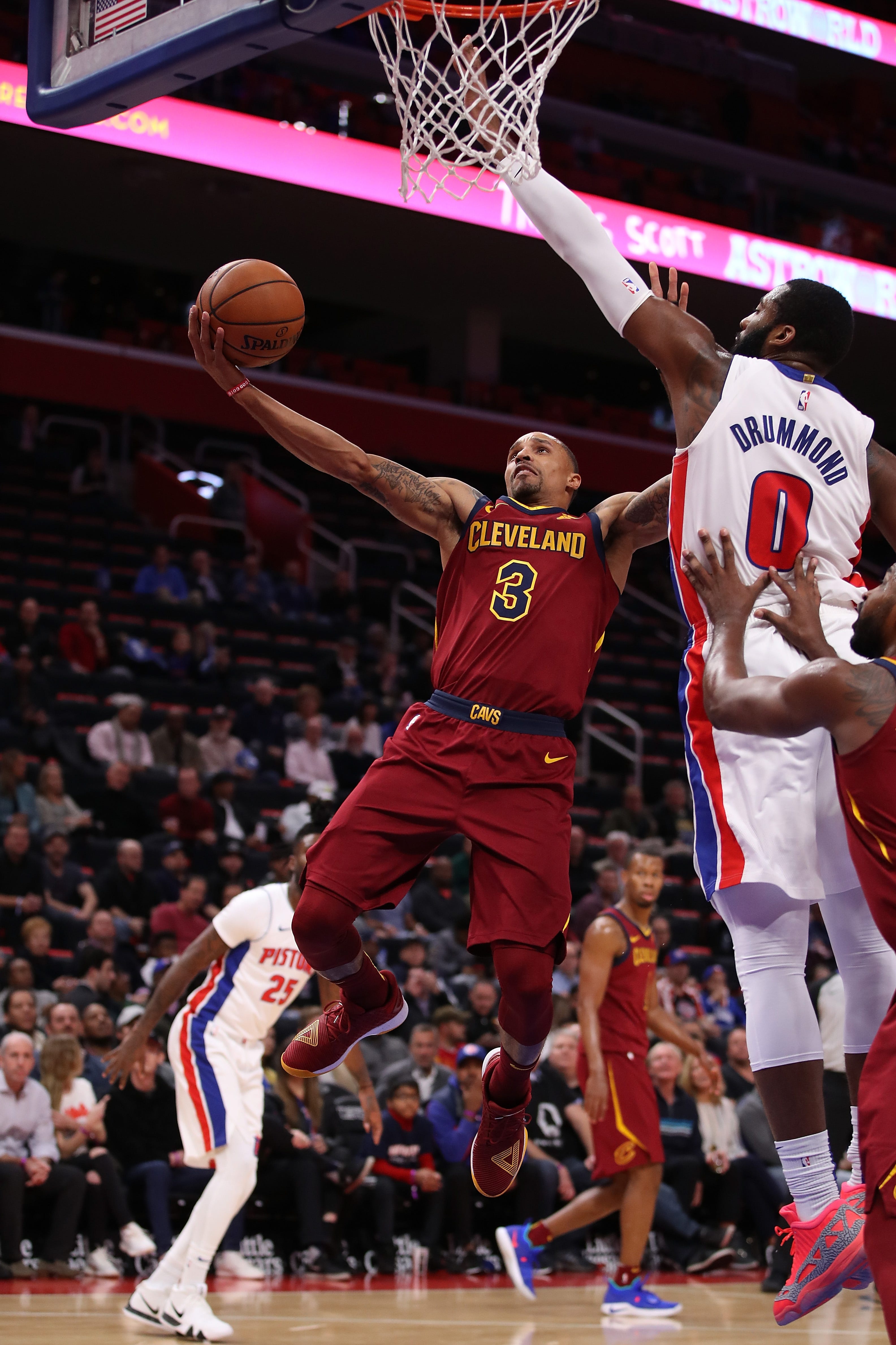George Hill (3) of the Cleveland Cavaliers drives to the basket past Andre Drummond (0) of the Detroit Pistons during the first half.