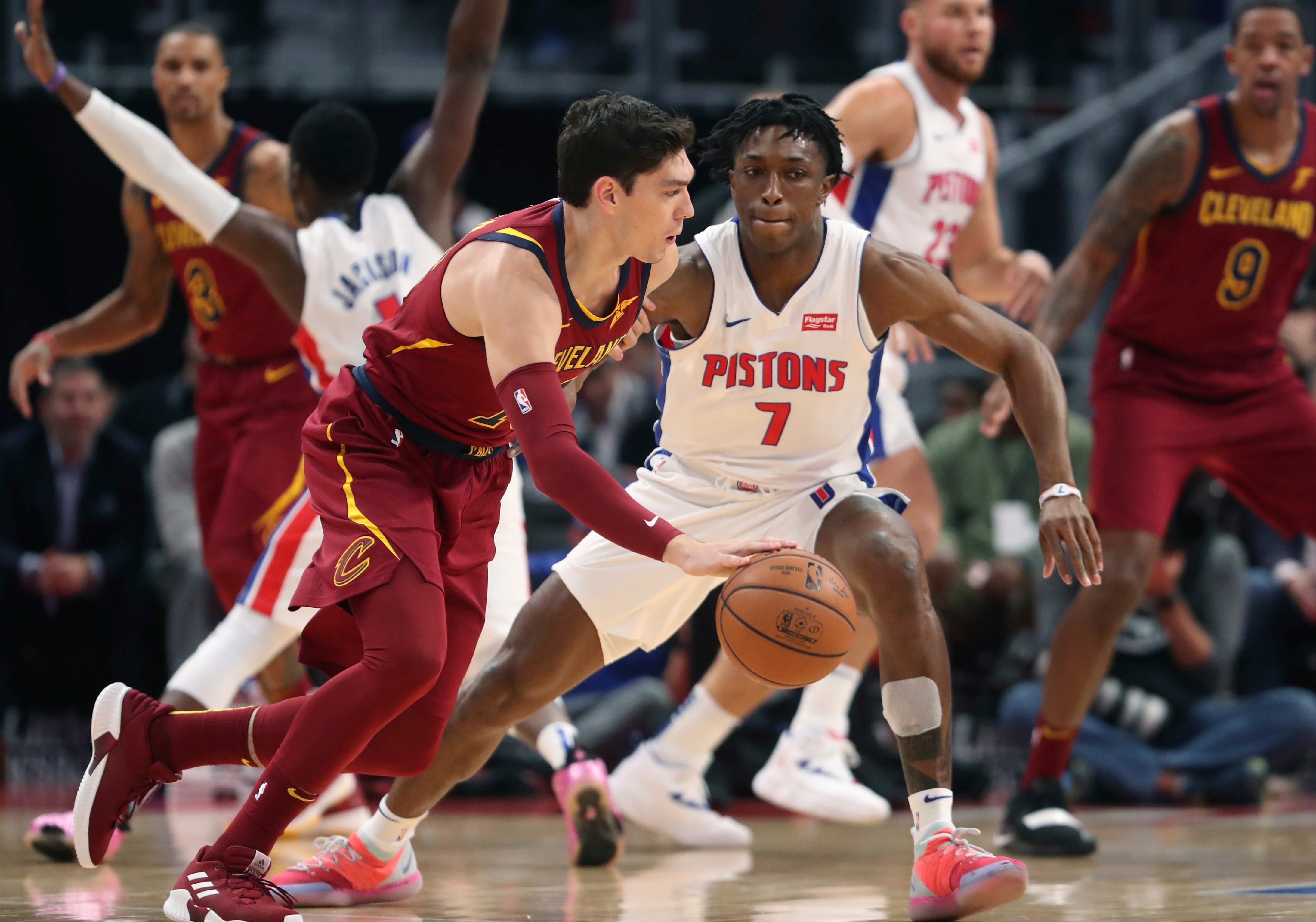 Cleveland Cavaliers forward Cedi Osman, front left, drives around Detroit Pistons forward Stanley Johnson (7) during the first half.