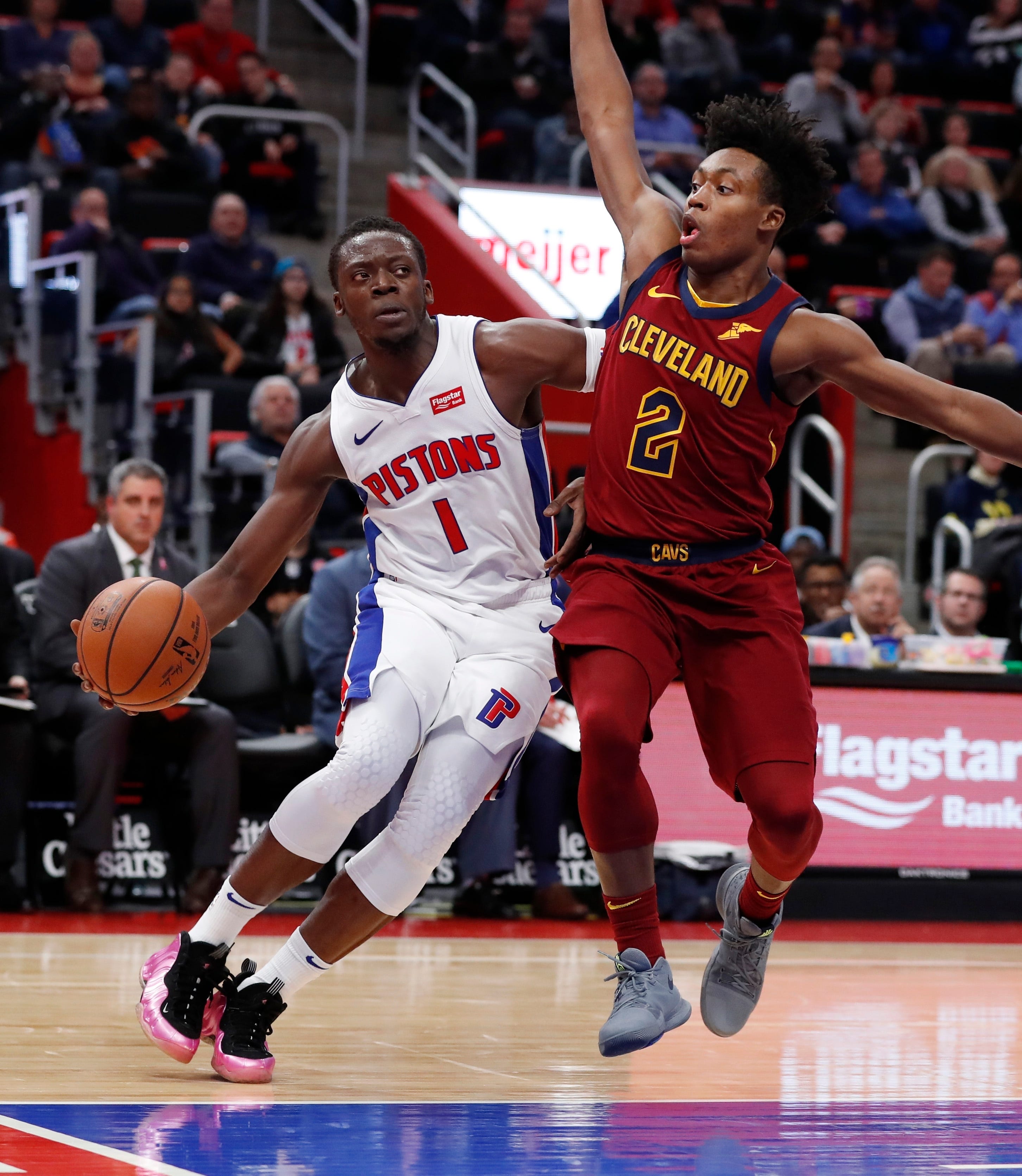 Detroit Pistons guard Reggie Jackson (1) is defended by Cleveland Cavaliers guard Collin Sexton (2) during the first half.