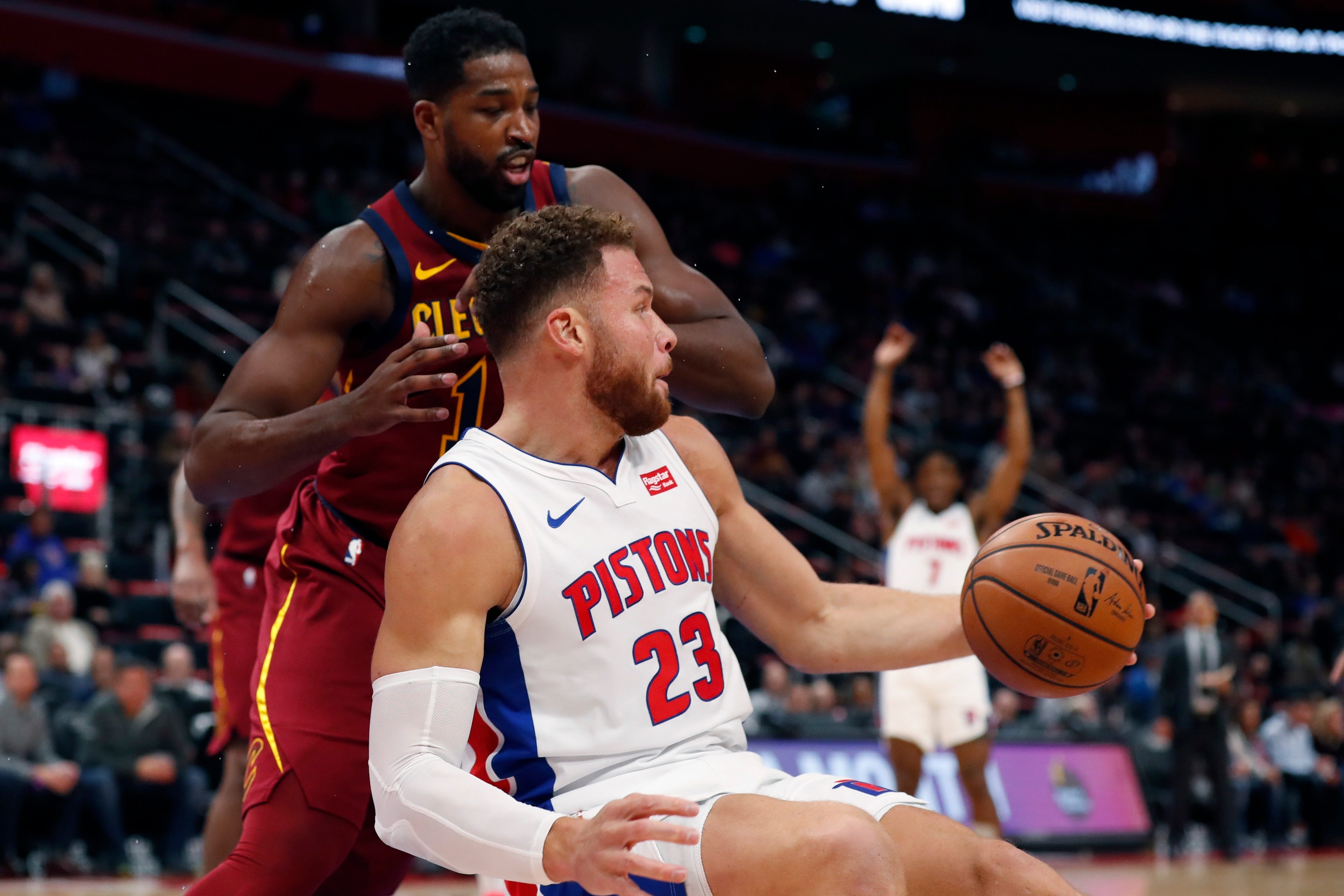 Detroit Pistons forward Blake Griffin (23) prepares to pass the ball as he falls next to Cleveland Cavaliers center Tristan Thompson during the first half.