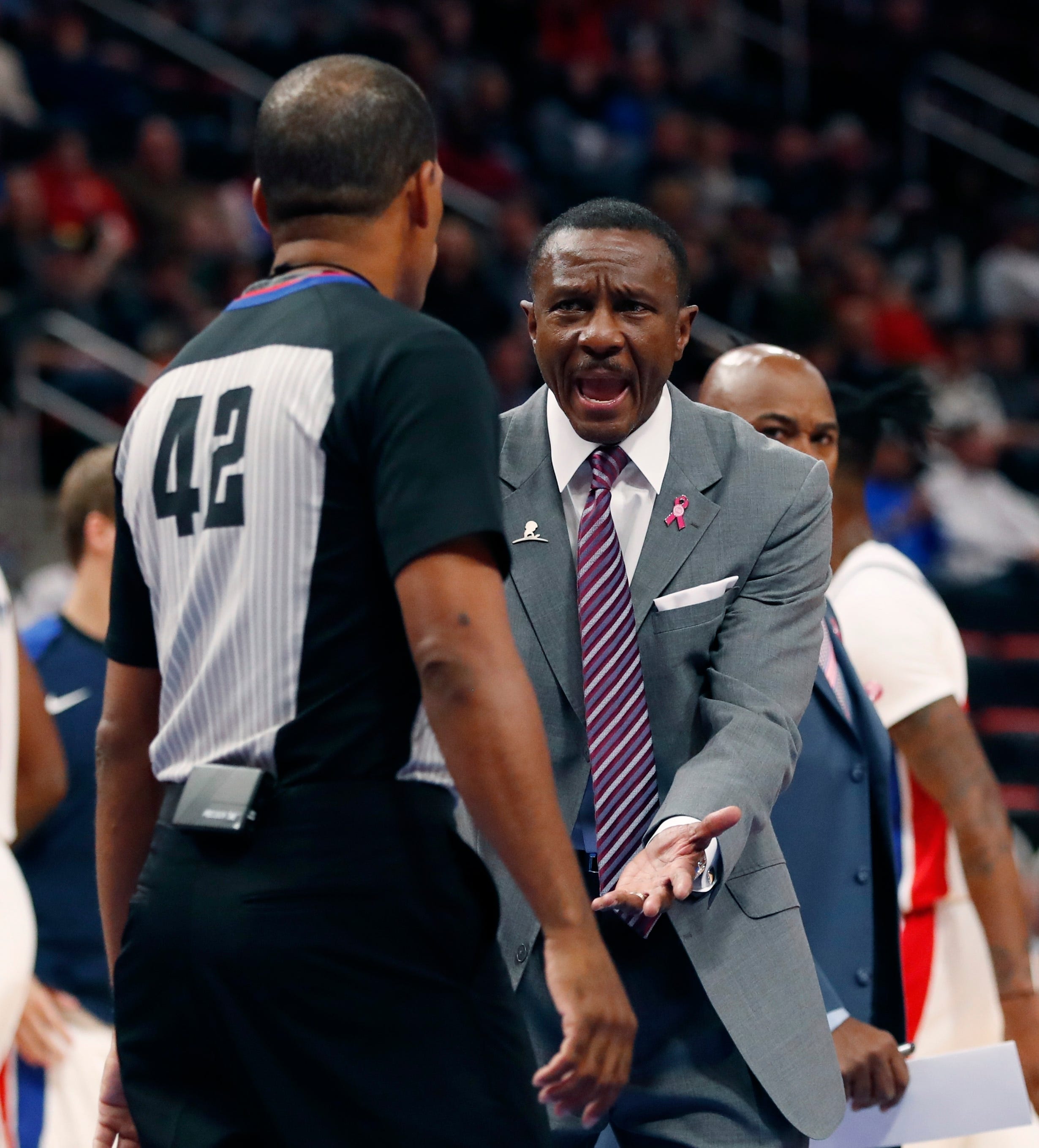 Detroit Pistons head coach Dwane Casey, right, argues a call with referee Eric Lewis (42) during the first half.