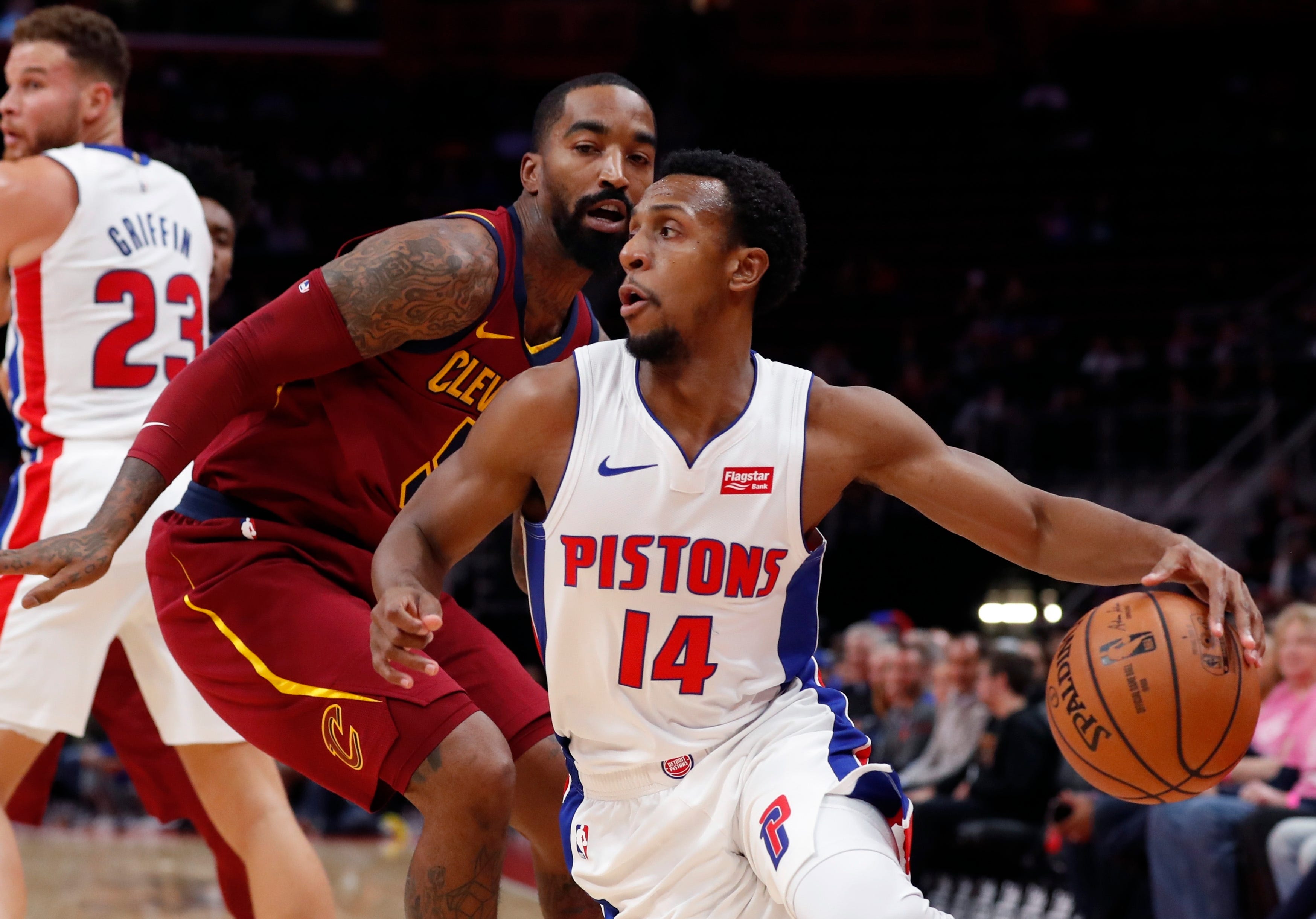 Detroit Pistons guard Ish Smith (14) drives on Cleveland Cavaliers guard JR Smith during the first half of an NBA basketball game, Thursday, Oct. 25, 2018, in Detroit.