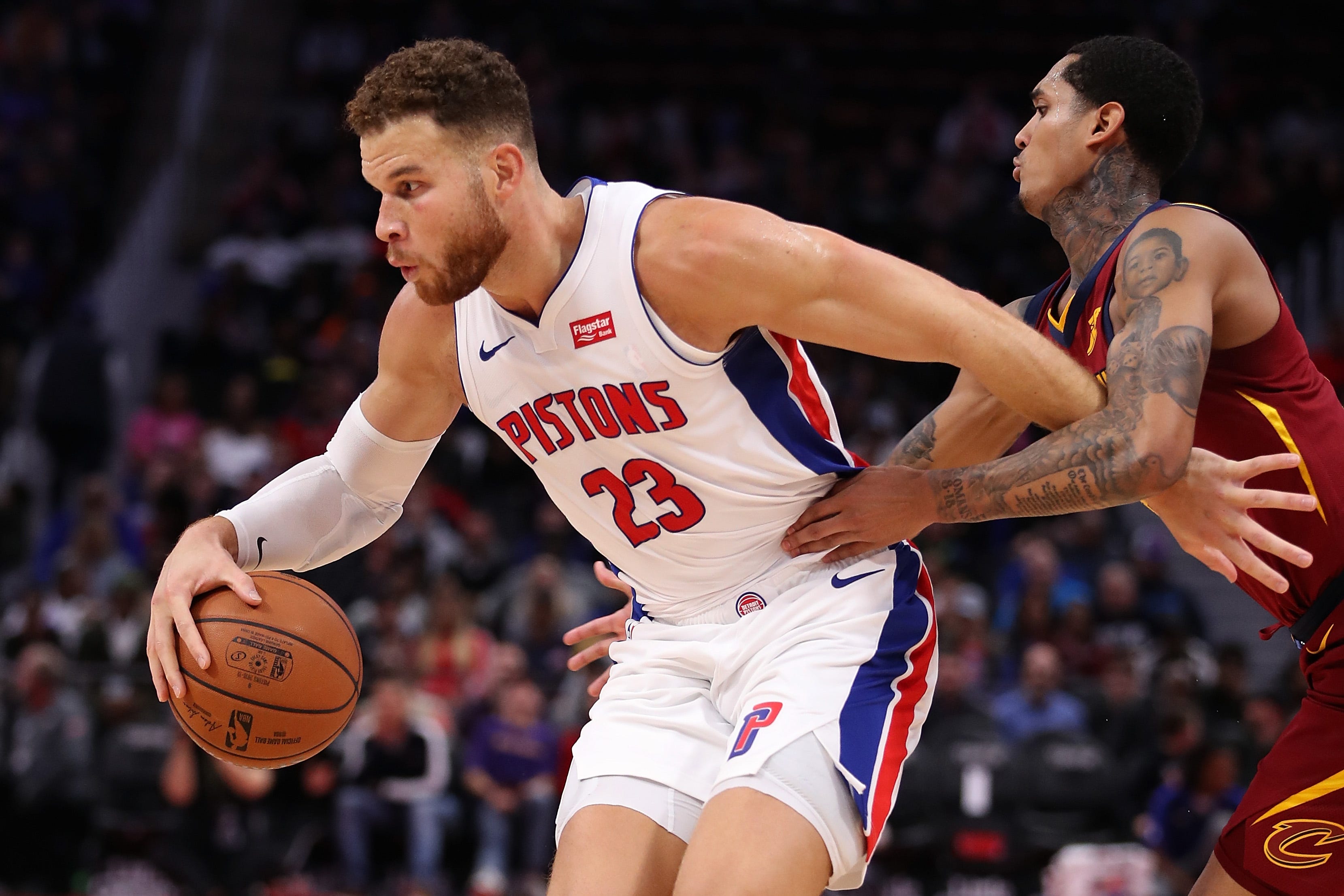 Blake Griffin (23) of the Detroit Pistons tries to escape the defense of Jordan Clarkson (8) of the Cleveland Cavaliers during the second half.