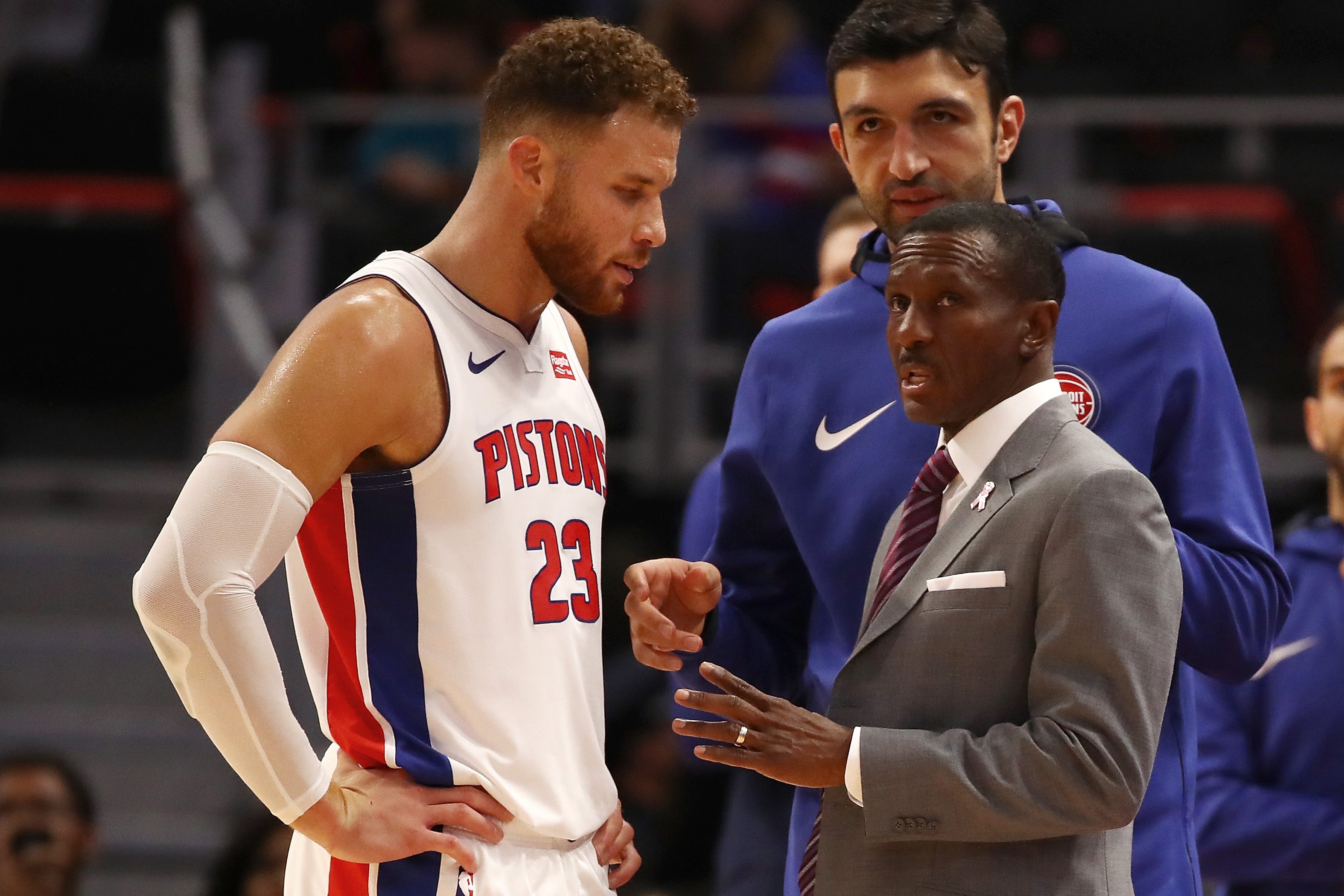 Head coach Dwane Casey of the Detroit Pistons talks with Blake Griffin.