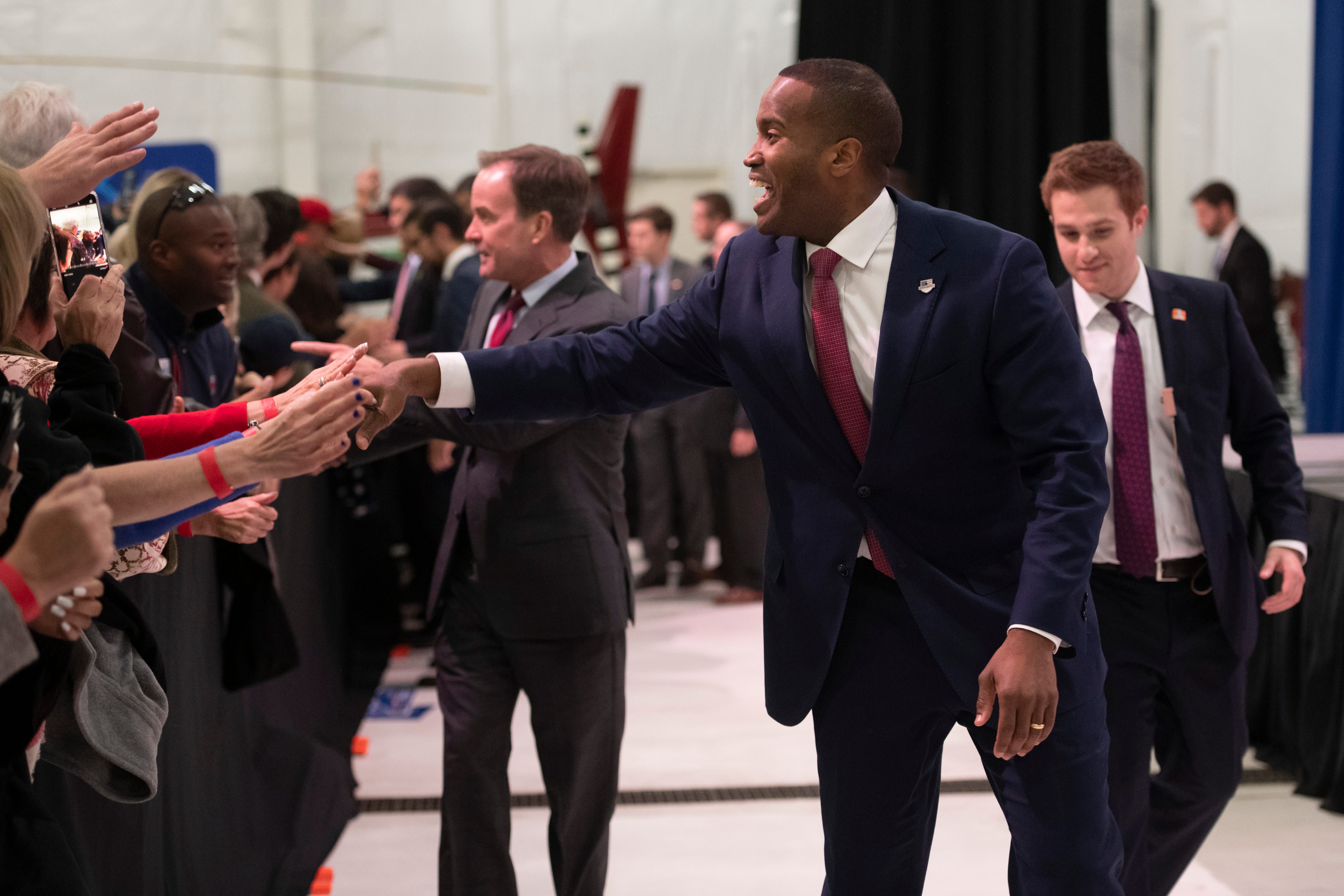 U.S. senate candidate John James shakes hands with supporters at the end of the rally.