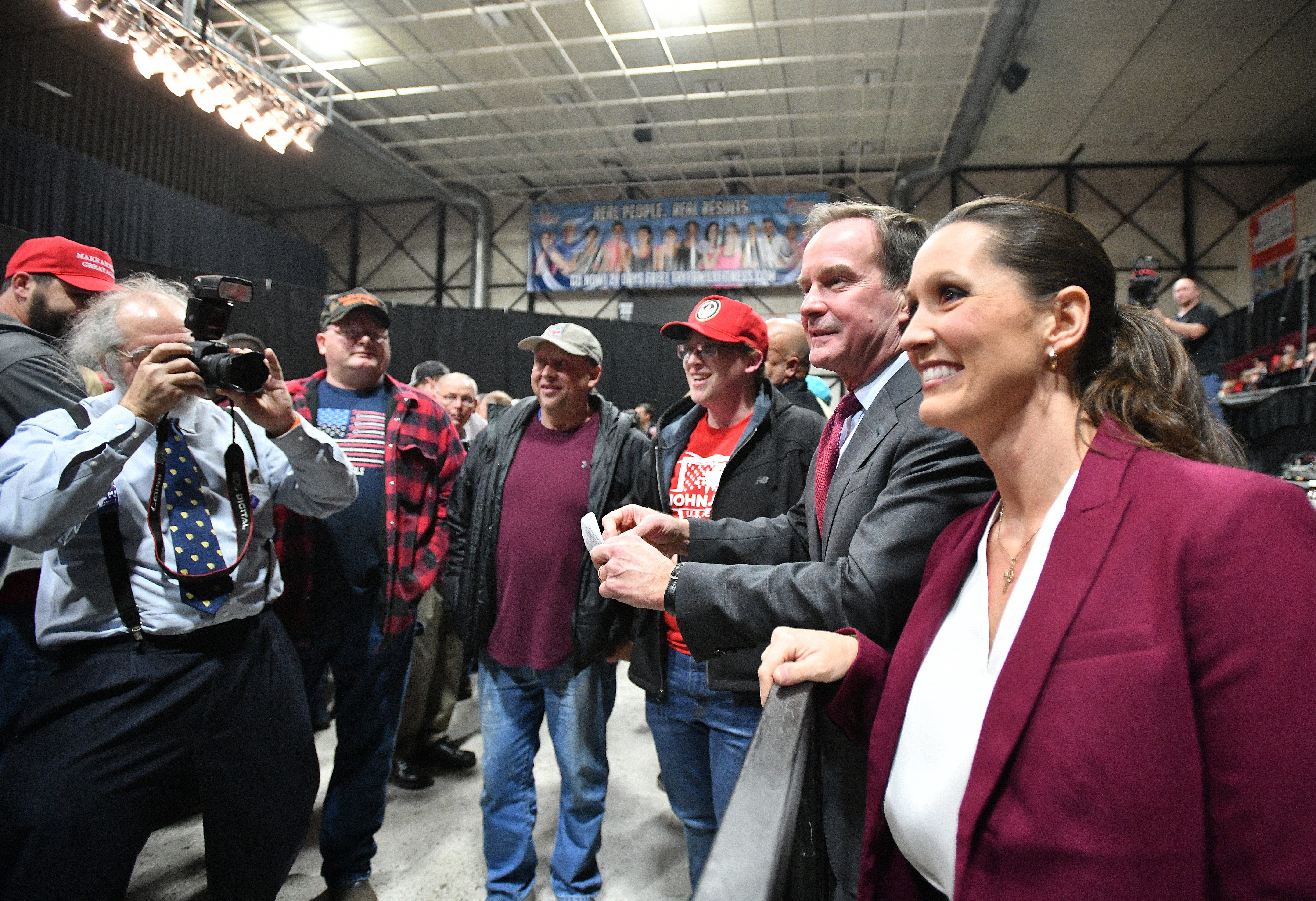 Bill Schuette and Lisa Posthumus Lyons greet fans before Vice President Mike Pence campaigns with Republican candidates.