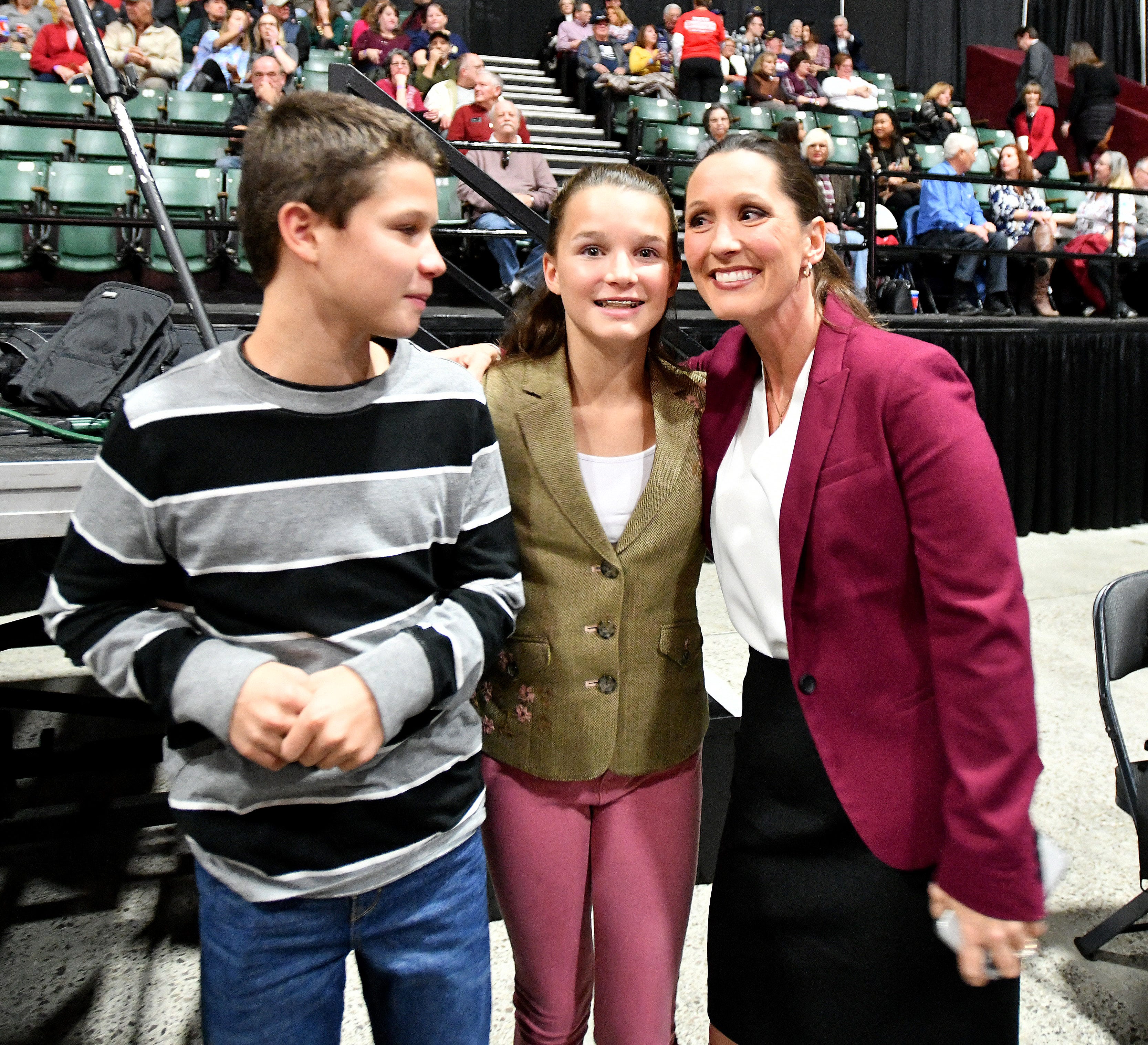 Lisa Posthumus Lyons poses with two of her four children — Easton and Charlie — before Vice President Mike Pence campaigns with Republican candidates at the DeltaPlex in Grand Rapids on Monday, Oct 29, 2018.