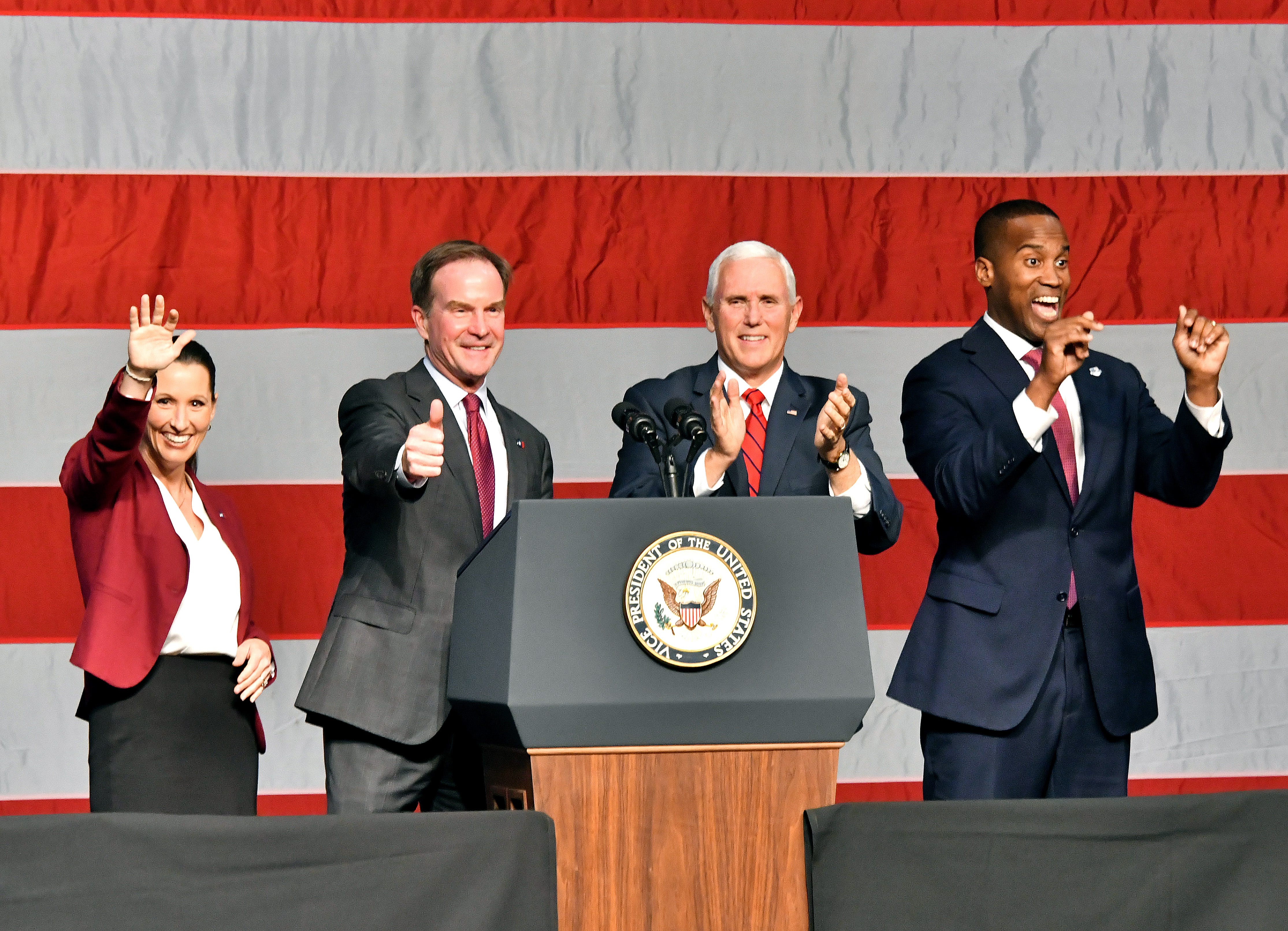 Laura Posthumus Lyons, Bill Schuette, Vice President Mike Pence and John James wave at the crowd as the V.P. campaigns with Republican candidates at the DeltaPlex in Grand Rapids on Monday, Oct 29, 2018.
