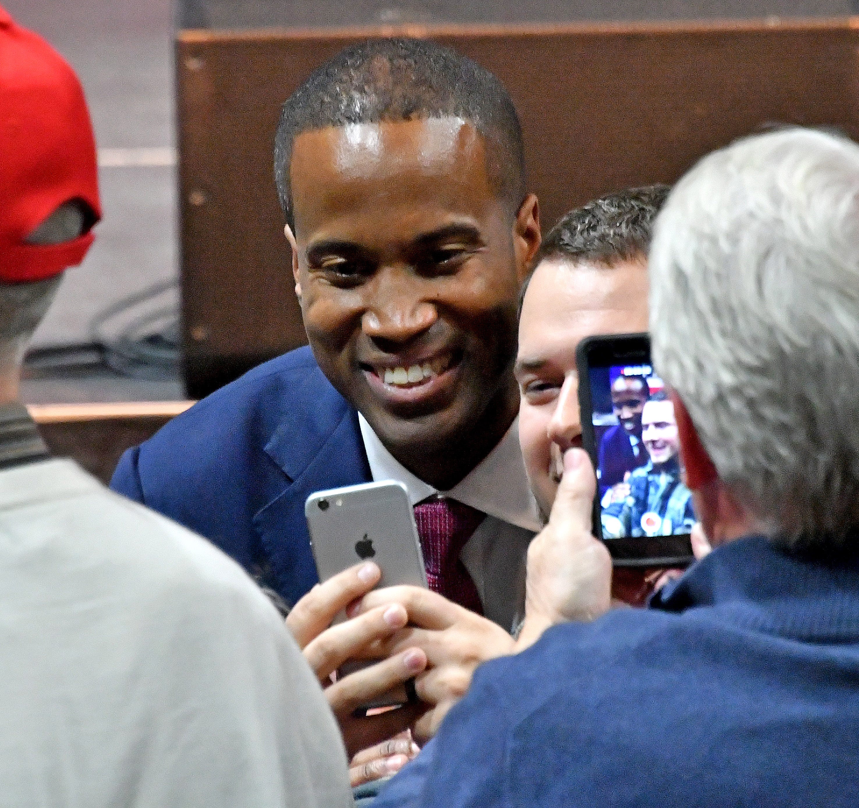 John James poses for a selfie with a supporter.