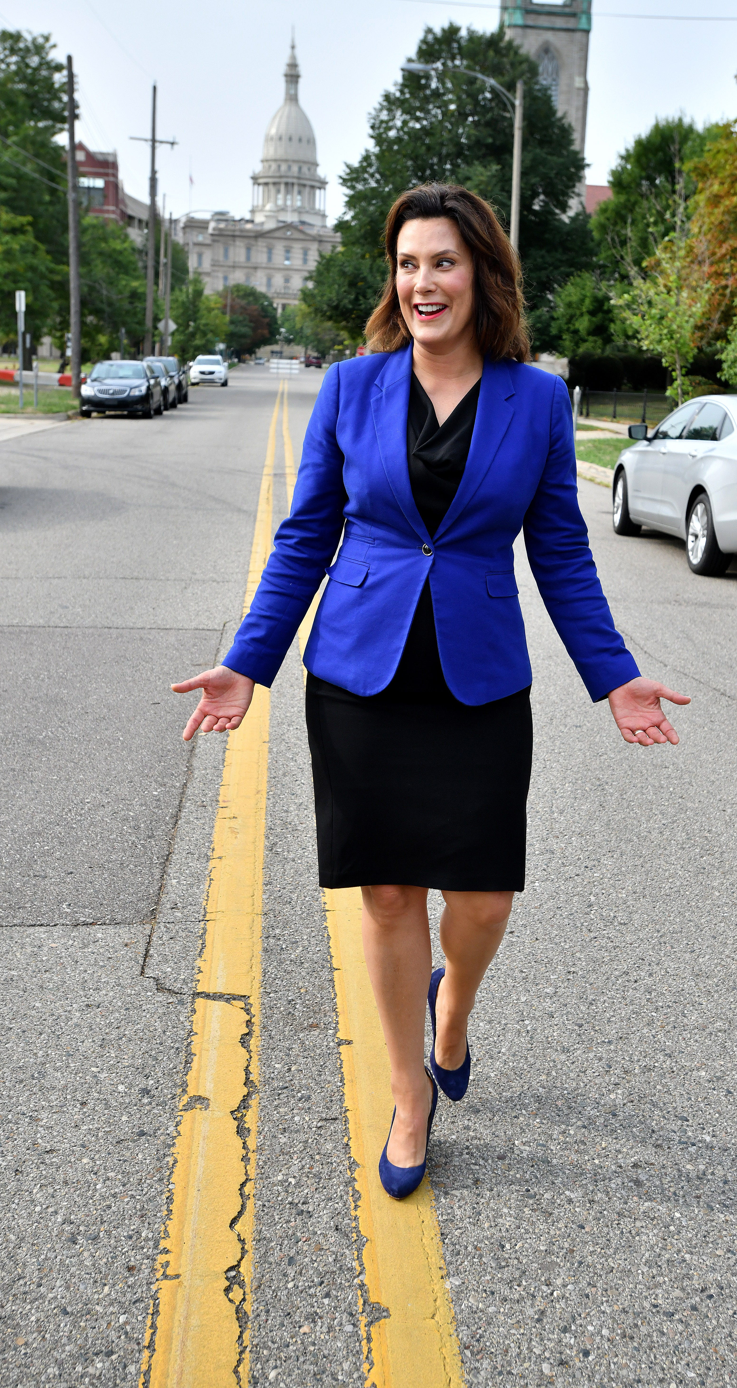 One of the photographers present asked Democratic candidate for governor, Gretchen Whitmer, to walk the line down the center of the road, during an event in downtown Lansing on Monday, Aug 20, 2018.
