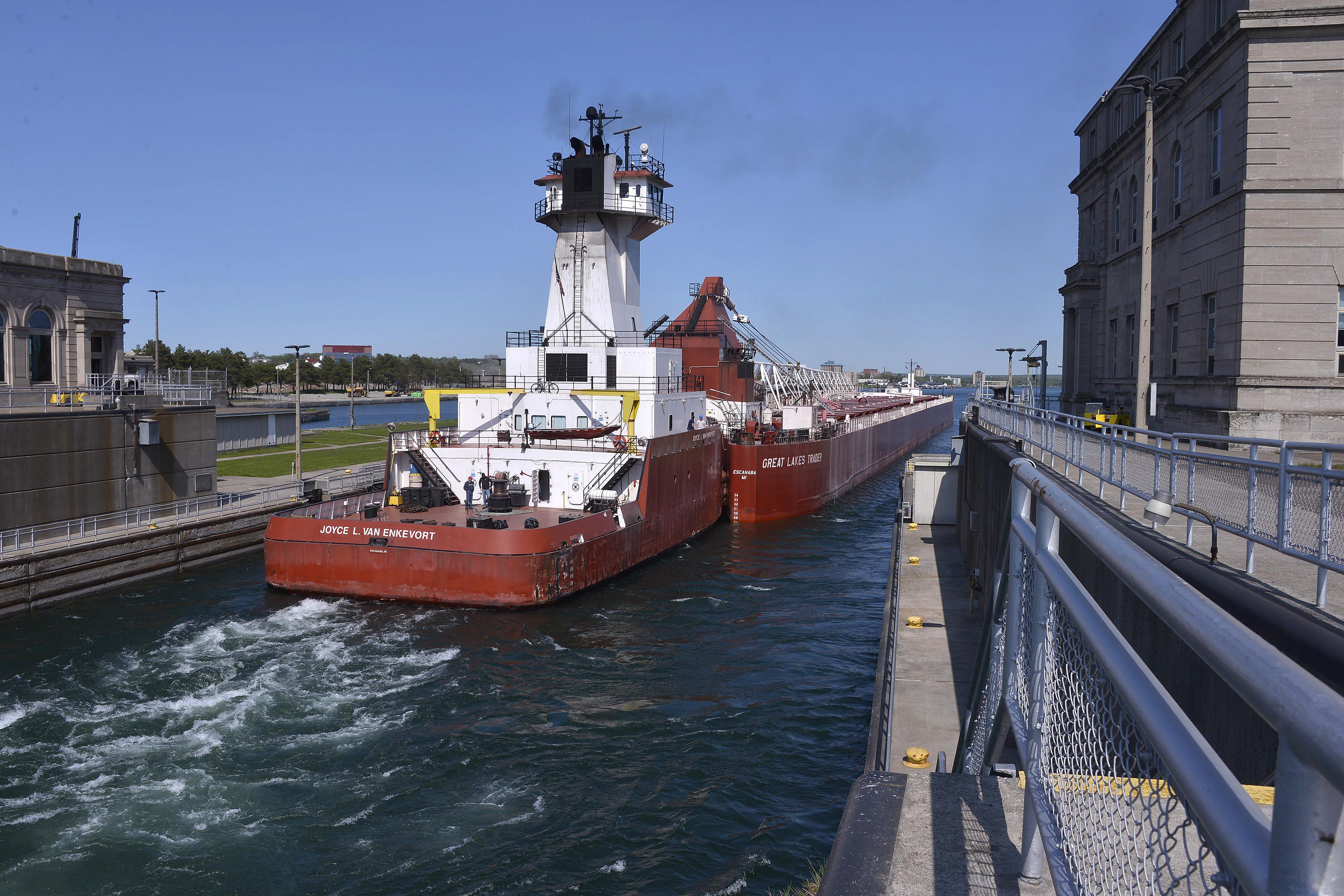 In this file photo, the Great Lakes Trader and the tug Joyce L. VanEnkevort exits the Poe Lock at the Soo Locks in Sault Ste. Marie.