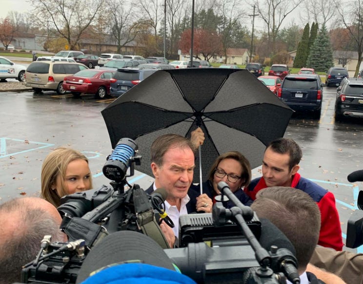 Republican gubernatorial candidate Bill Schuette arrives at his polling station in Midland, Michigan Tuesday surrounded by reporters.