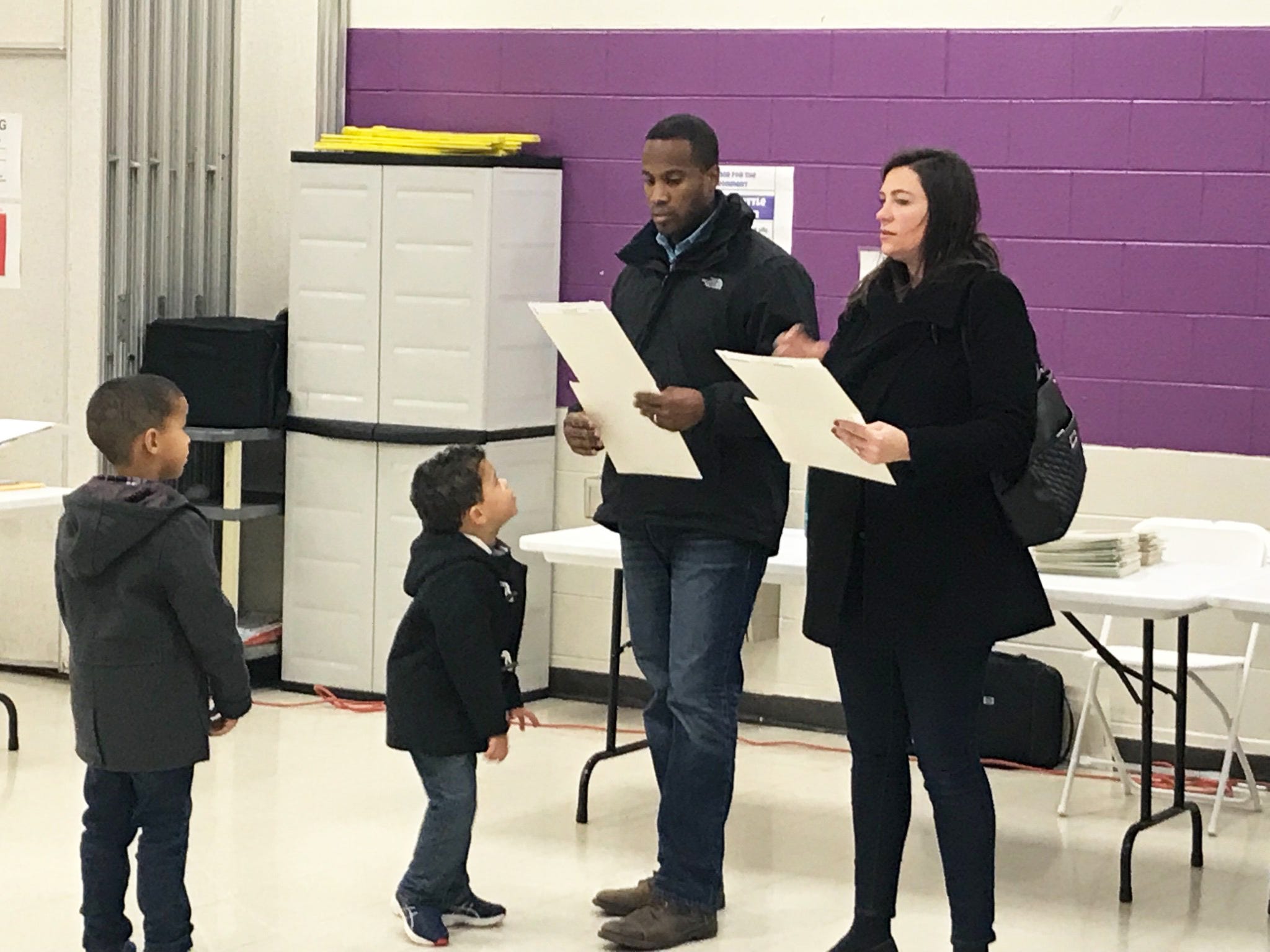 Republican U.S. Senate candidate John James votes with his wife Elizabeth and two sons Tuesday morning in Farmington Hills.