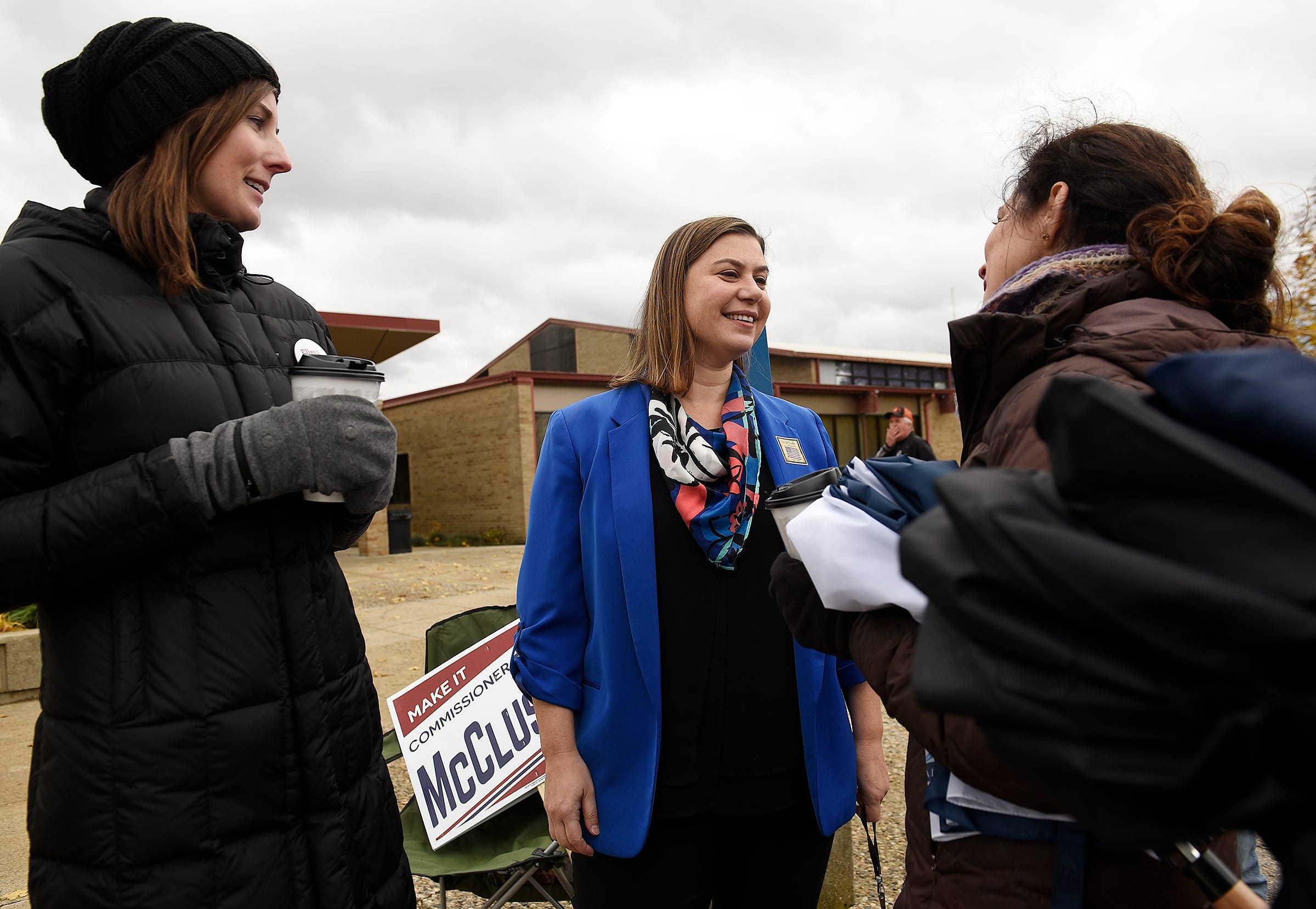Elissa Slotkin, Democratic candidate for U.S. House of Representatives, talks to supporters Leigh Fullenkamp, left, 35, of Columbus, Ohio, and sister-in-law Amy Gottesman, 41, of St. Louis after casting her ballot at the Karl Richter Community Center in Holly on Nov., 6, 2018.