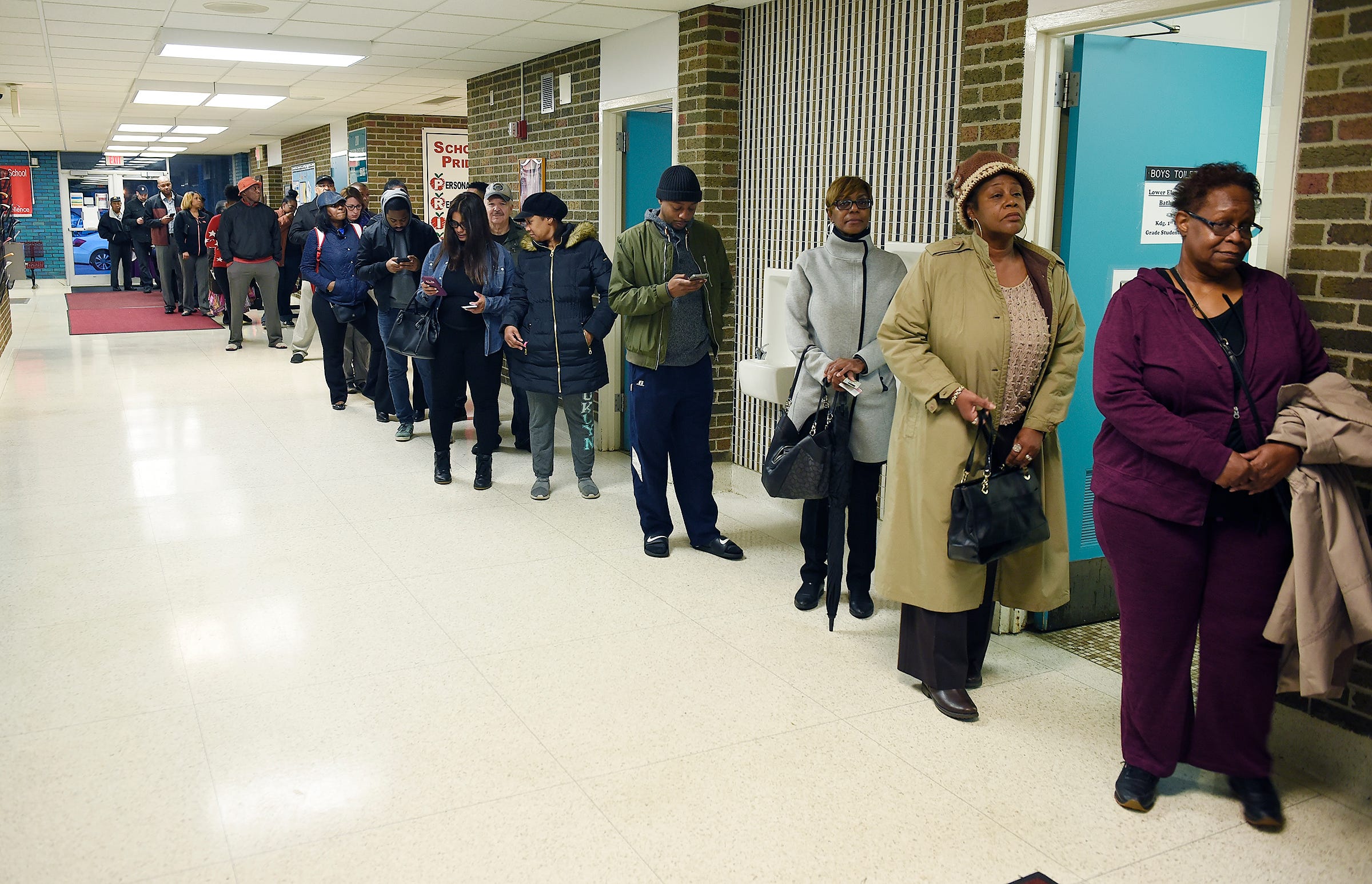 A long line of voters wait to vote Tuesday morning at Adler Elementary School in Southfield.