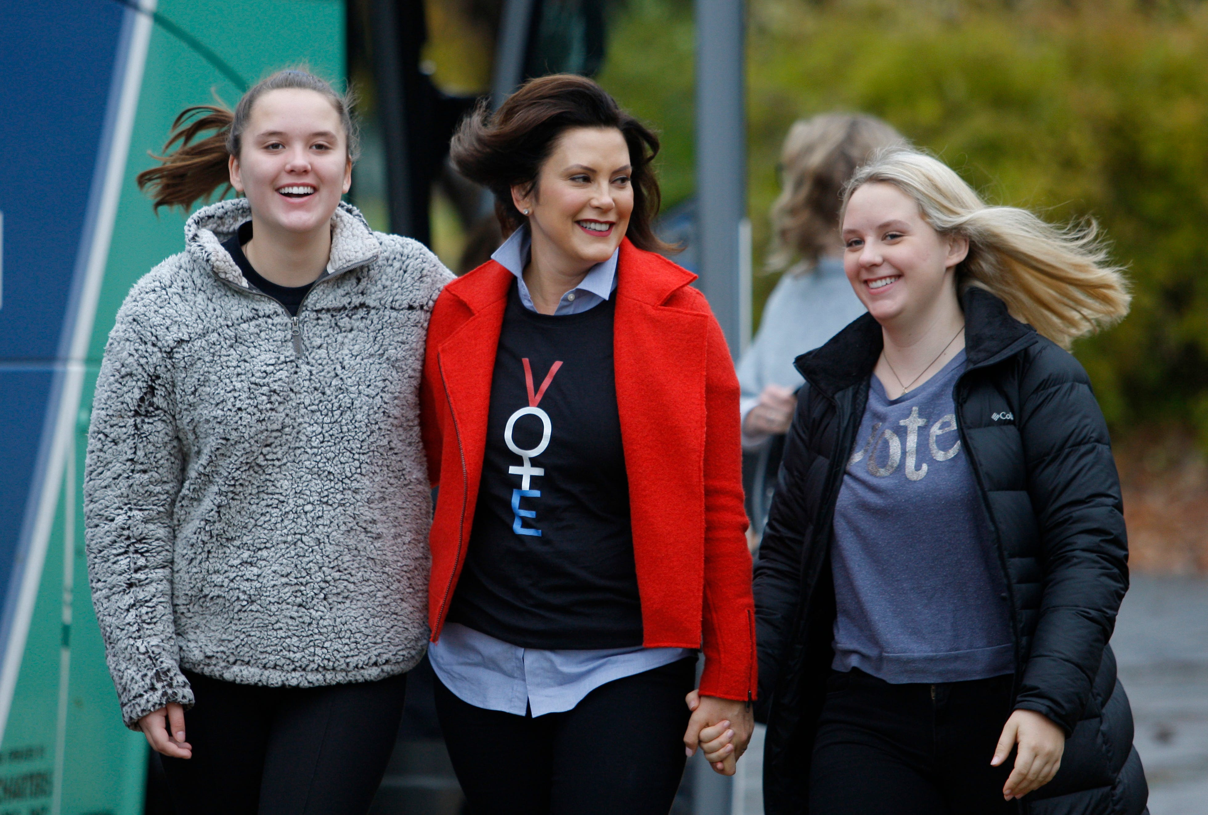 Michigan Democratic gubernatorial candidate Gretchen Whitmer, center, walks from her campaign bus to the polling place with daughters Sherry, left, and Sydney, Tuesday, Nov. 6, 2018, at St. Paul Lutheran Church in East Lansing.