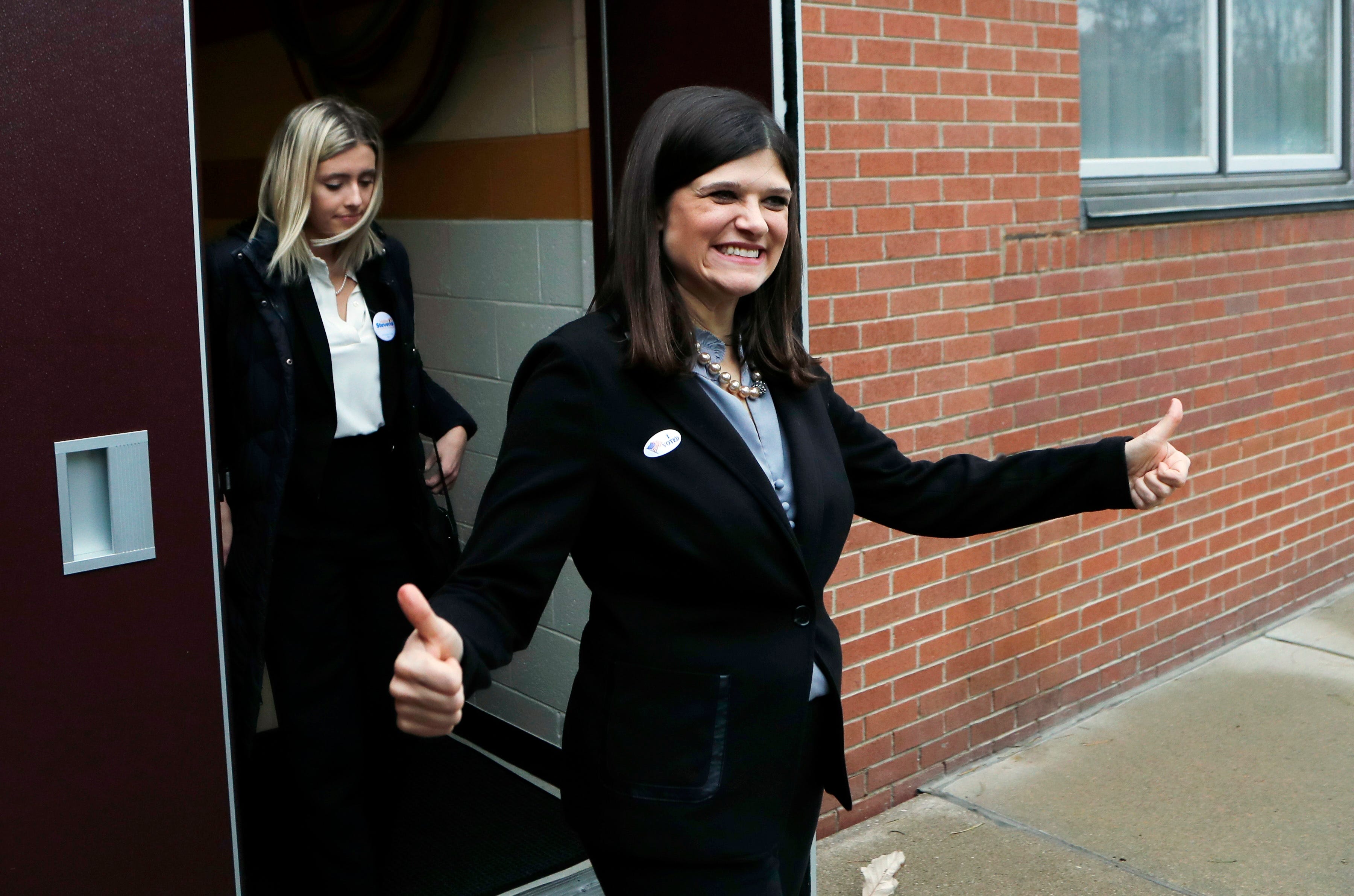 Haley Stevens, Democratic candidate for Michigan's 11th Congressional District, gives a thumbs up as she exits her polling place Tuesday,  in Rochester Hills.