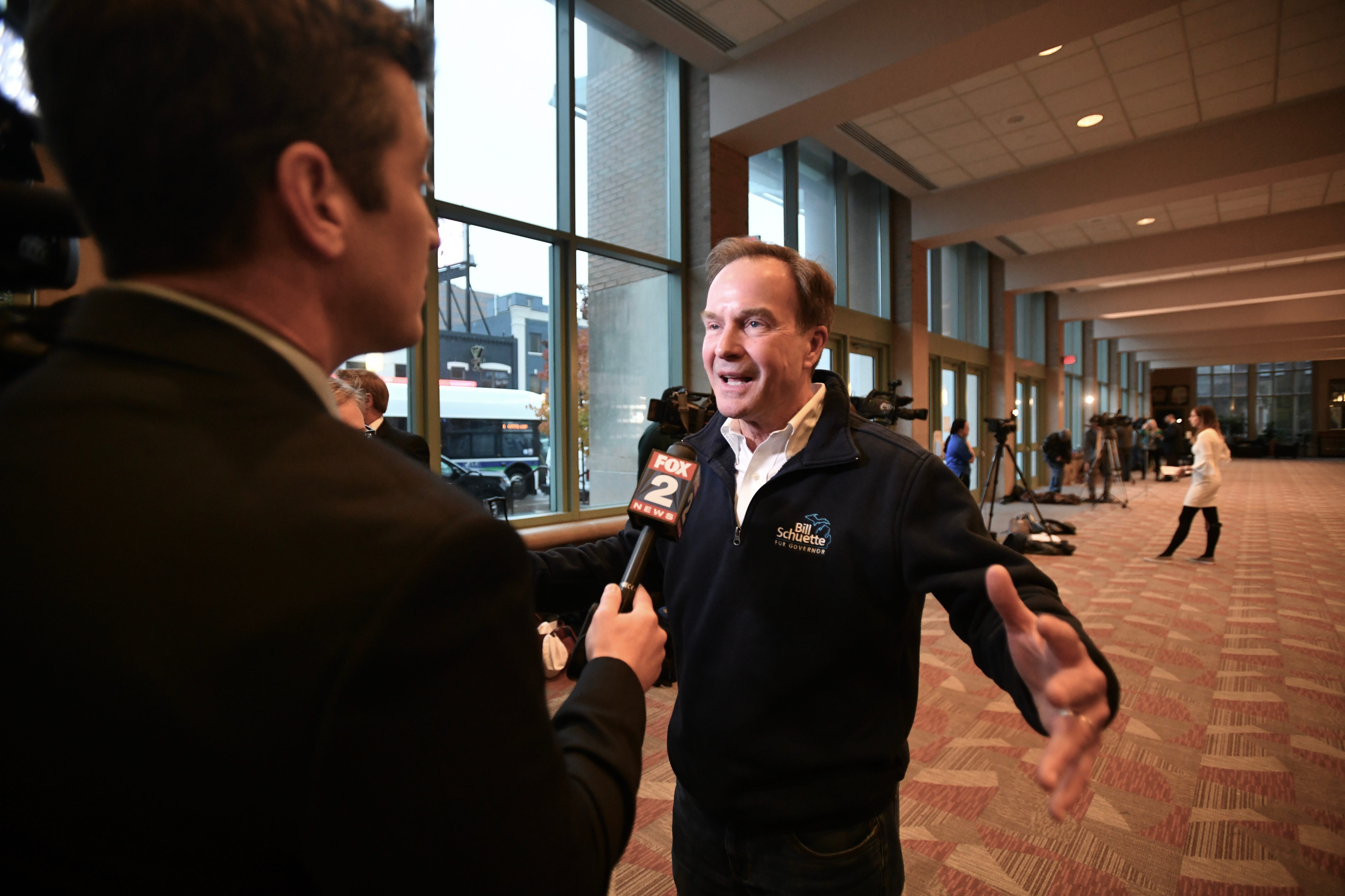 Bill Schuette talks with a TV reporter at the Lansing Center on Tuesday evening before the GOP election night party on November, 6, 2018.