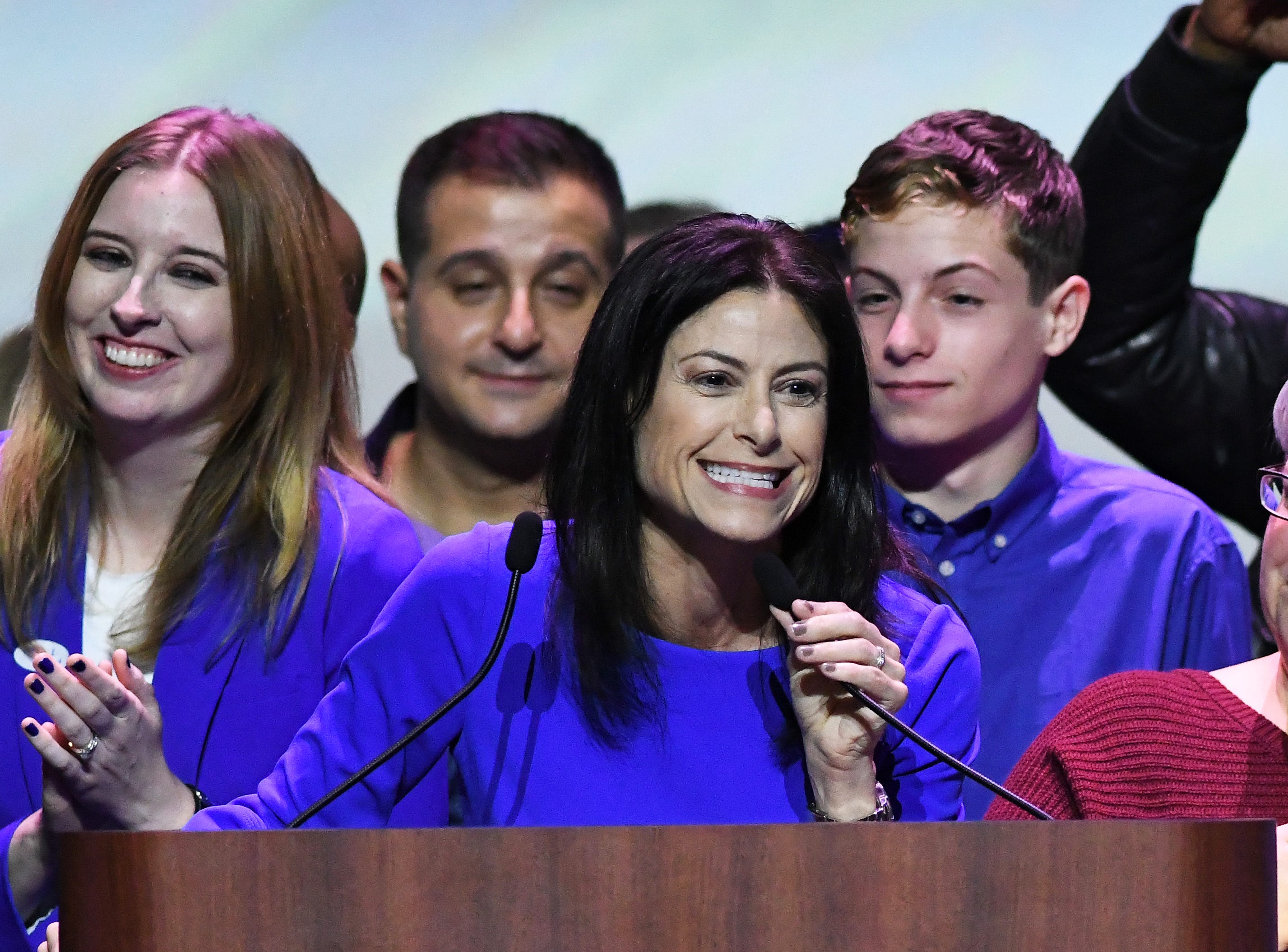 Michigan Attorney General candidate Dana Nessel thanks supporters at the Democrats' election night party in Detroit. At left is her wife,  Alanna Maguire
