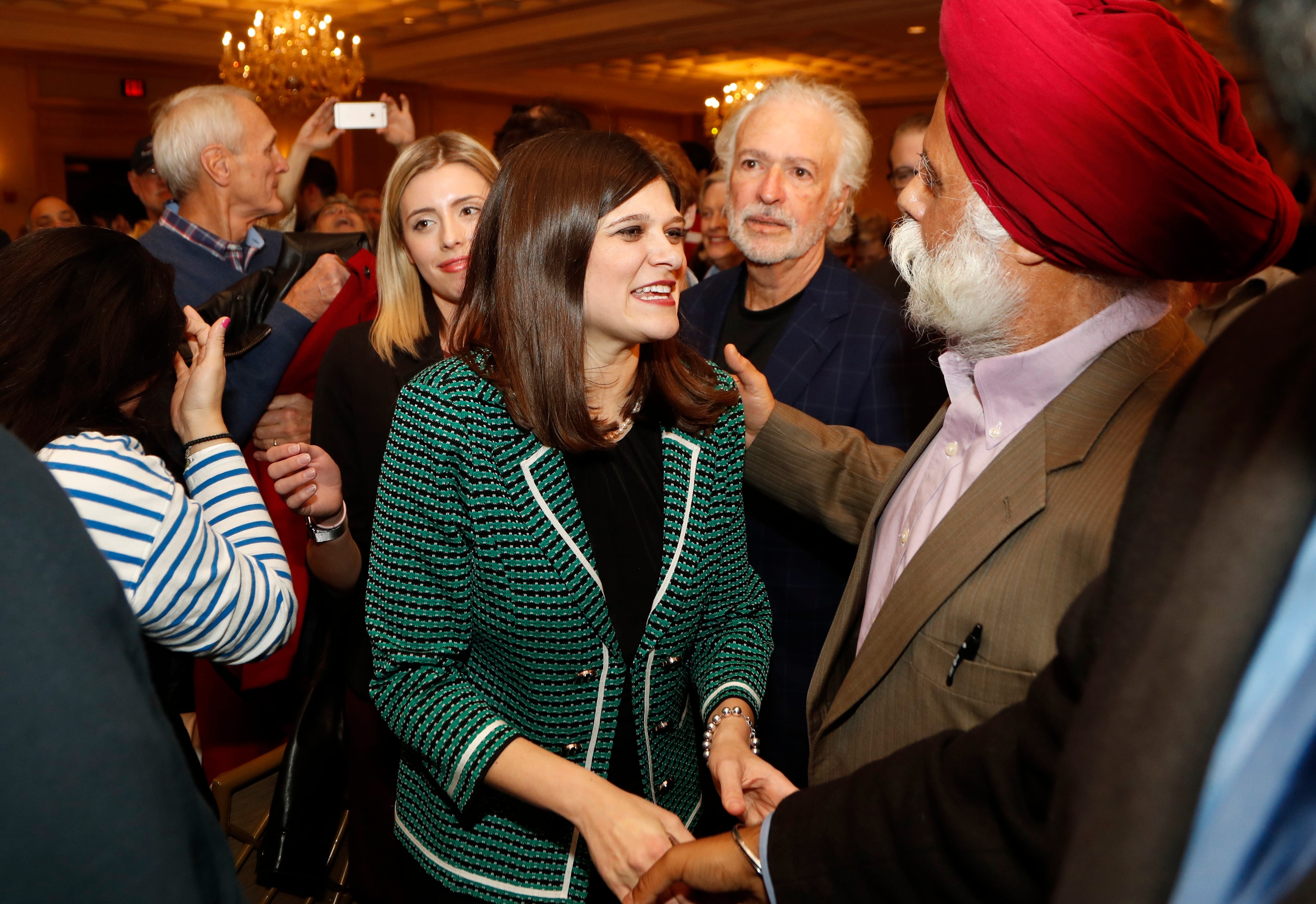Haley Stevens, candidate for Michigan's 11th Congressional District seat,  greets supporters at an election night party in Birmingham.