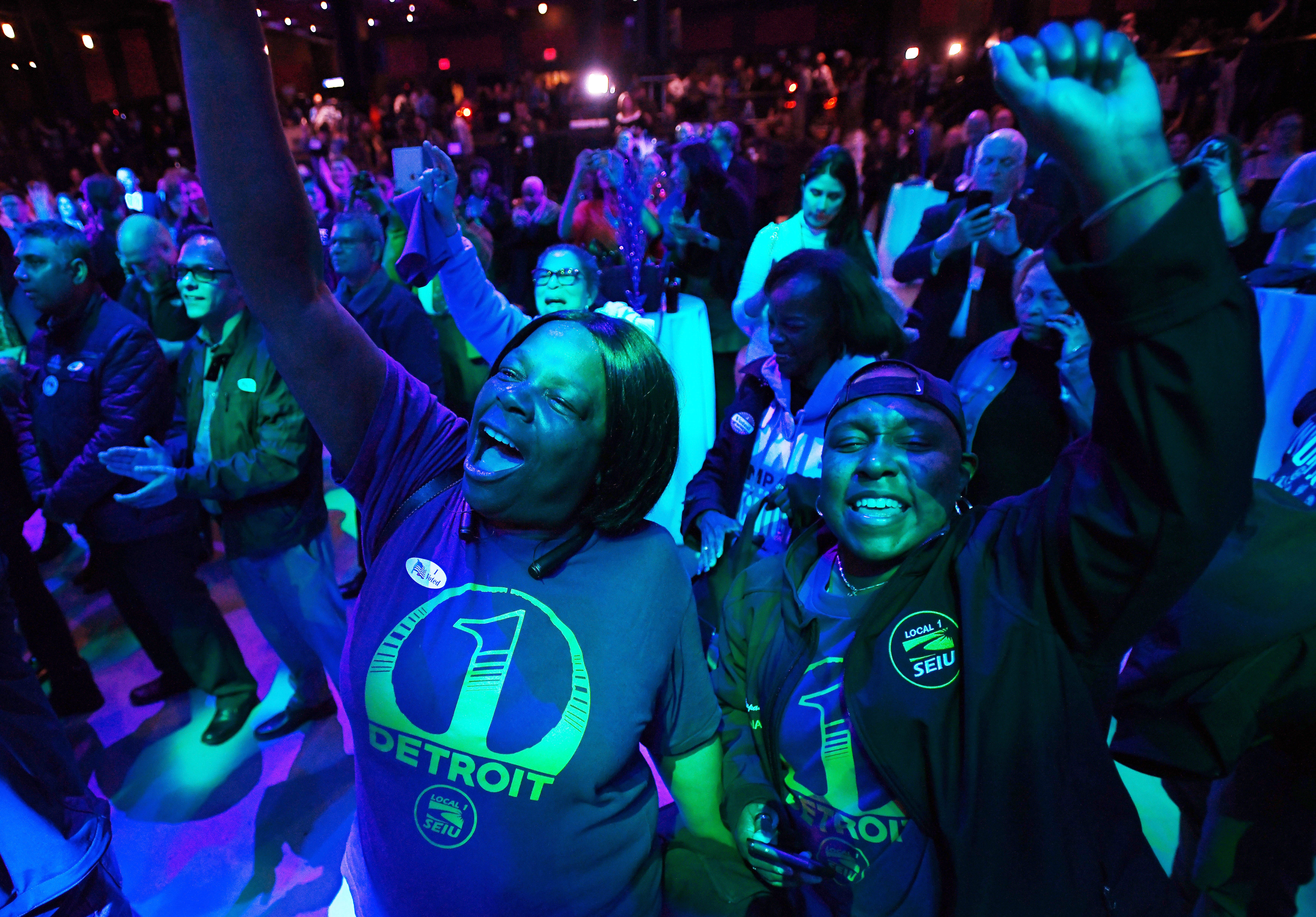 Kim Williams and Paulette Compass, both with SEIU, cheer as Detroit Mayor Mike Duggan tells the Democratic crowd at MotorCity Casino's Sound Board that  Michigan gubernatorial candidate Gretchen Whitmer is in the lead in the early results.