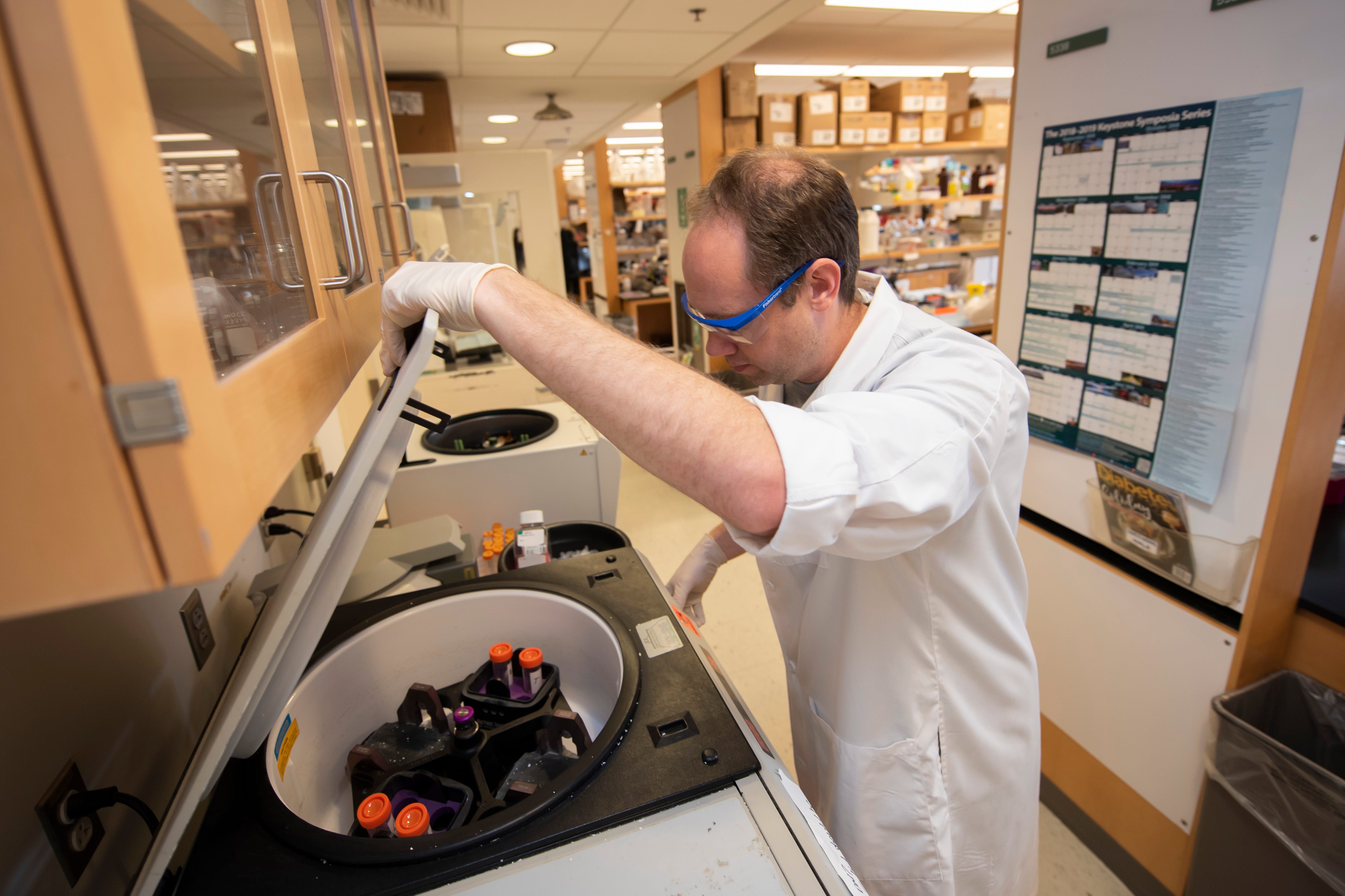 Research investigator Ben Murdock uses a centrifuge to help isolate immune cells from spinal cord tissue at the Program for Neurology Research and Discovery inside the Taubman Biomedical Science Research Building at the University of Michigan in Ann Arbor.