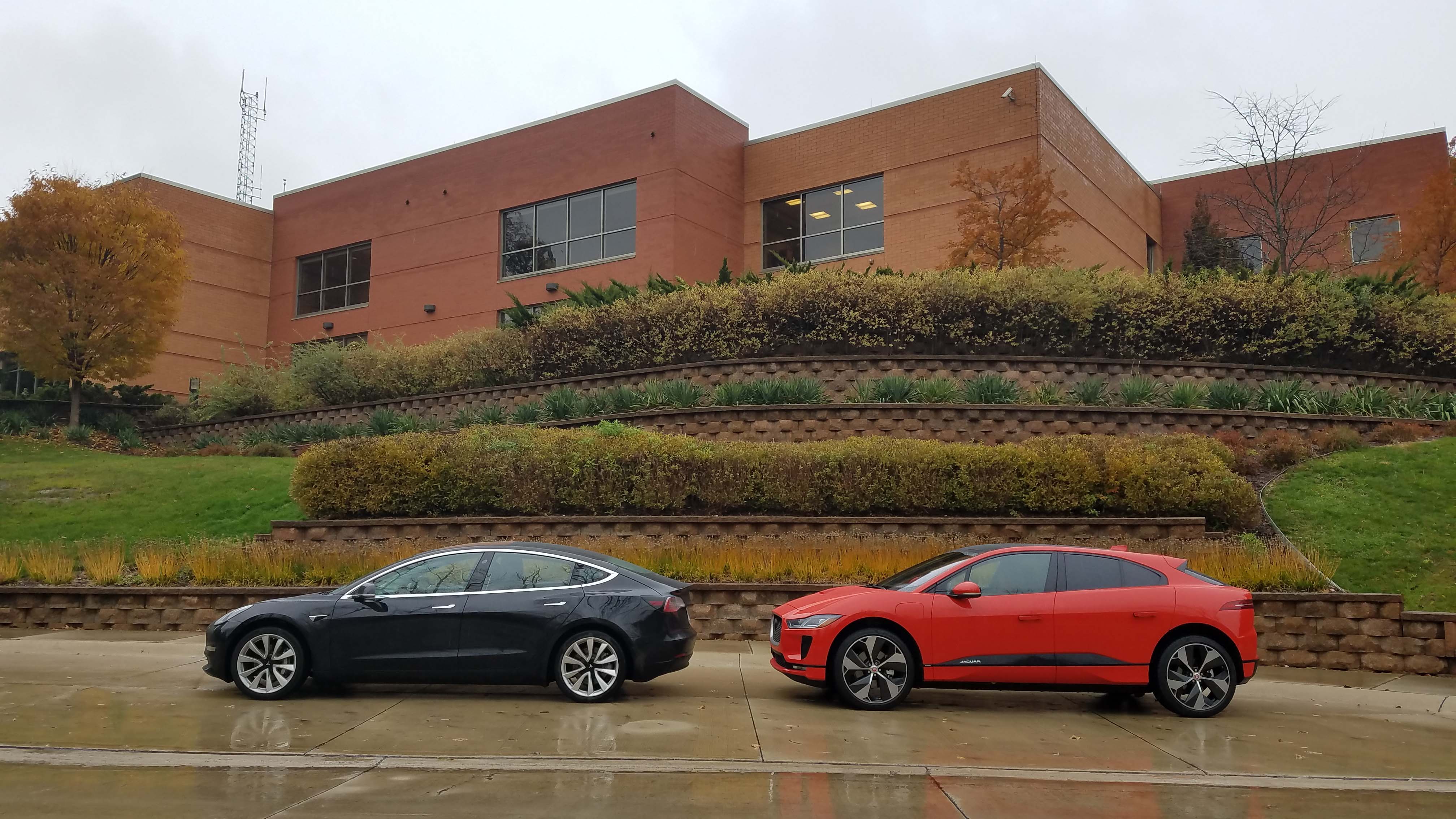 The Tesla Model 3's styling simplicity is striking next to fellow EV Jaguar I-Pace. The interior is even more spare.