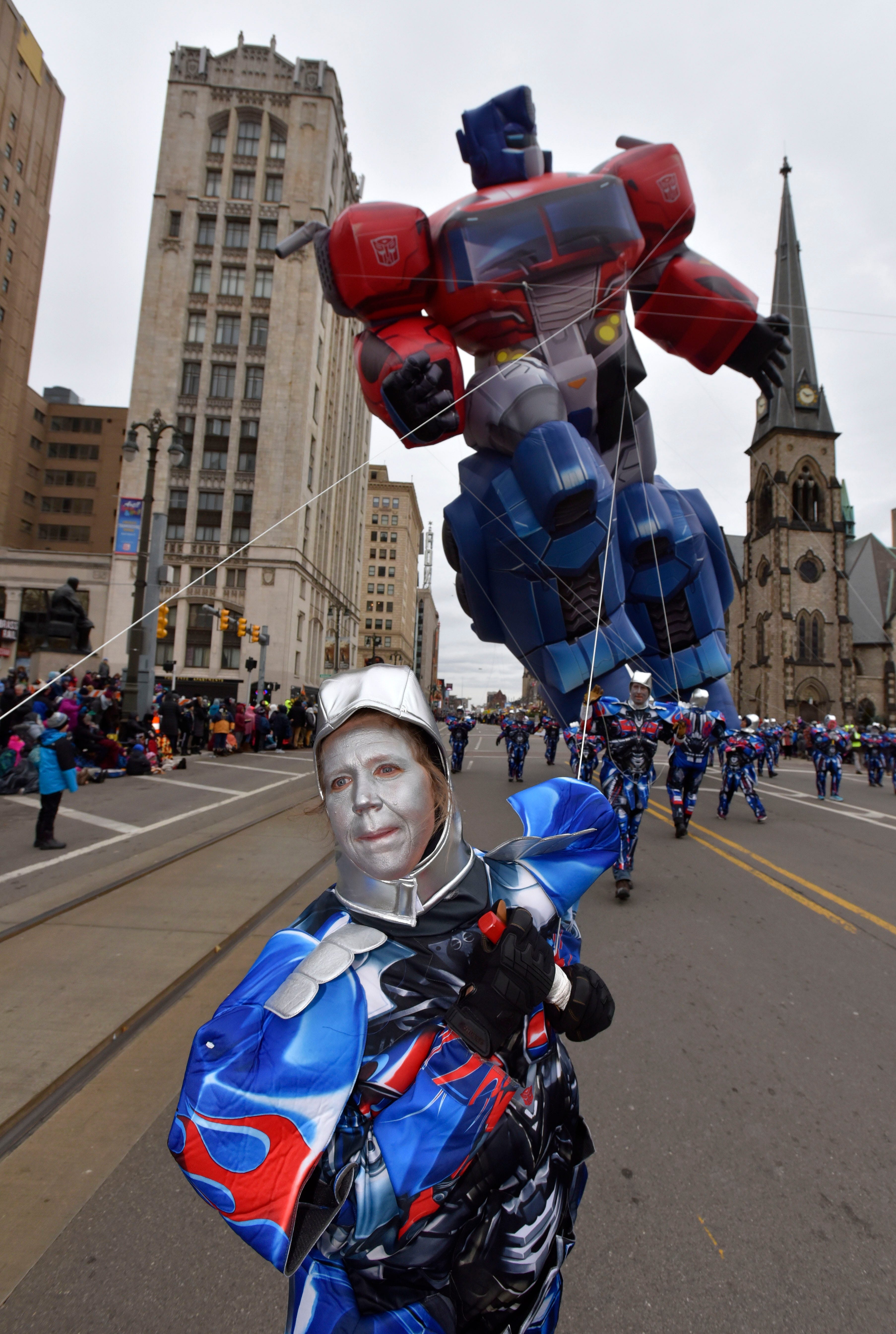 Volunteer Sarah Mickowski, of New Baltimore, keeps a tight hold on a line attached to Optimus Prime from Chemical Bank.