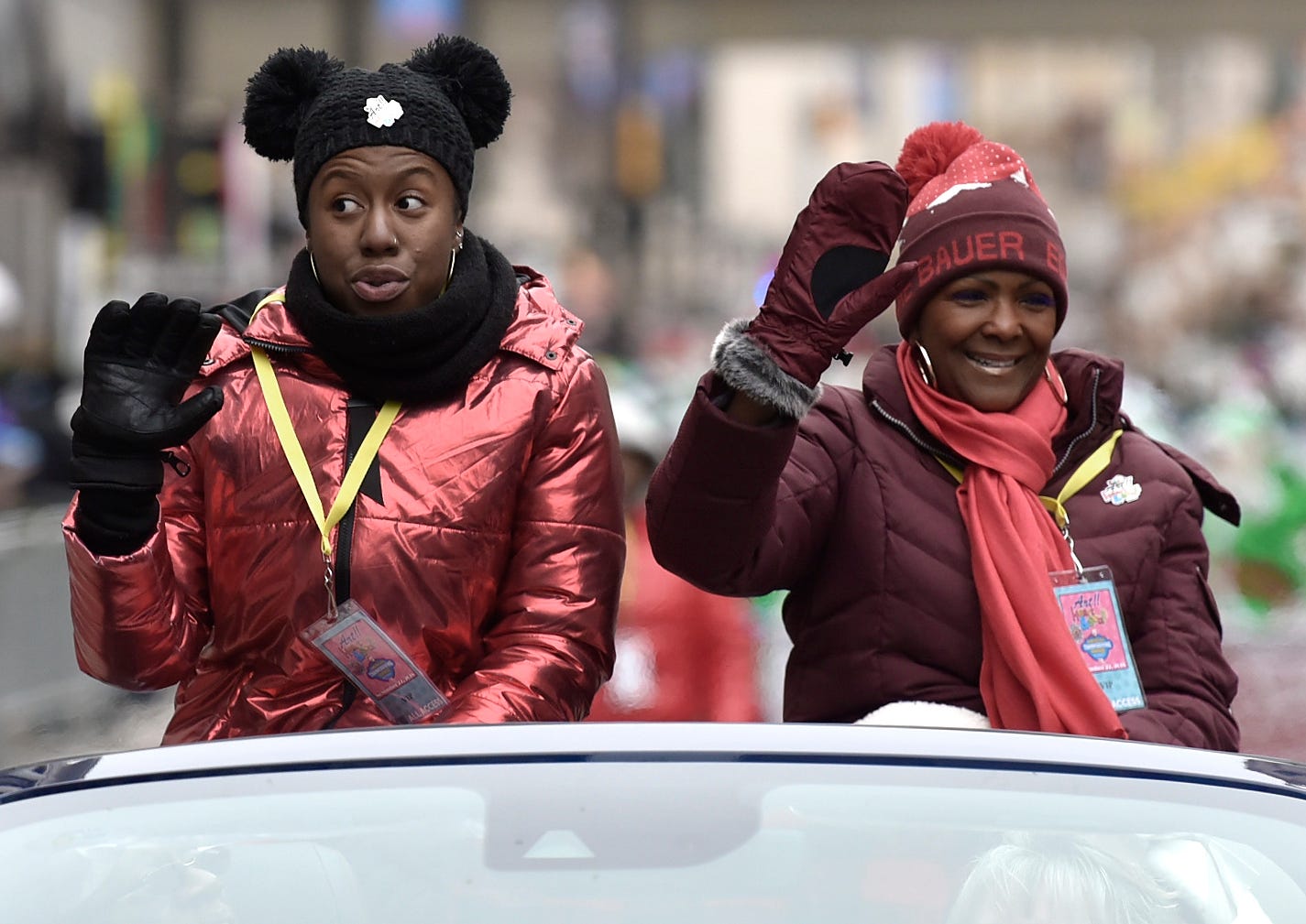 Aretha Franklin's nieces Brooklin Hardeman, left, and Sabrina Owens wave near the end of the parade. .
