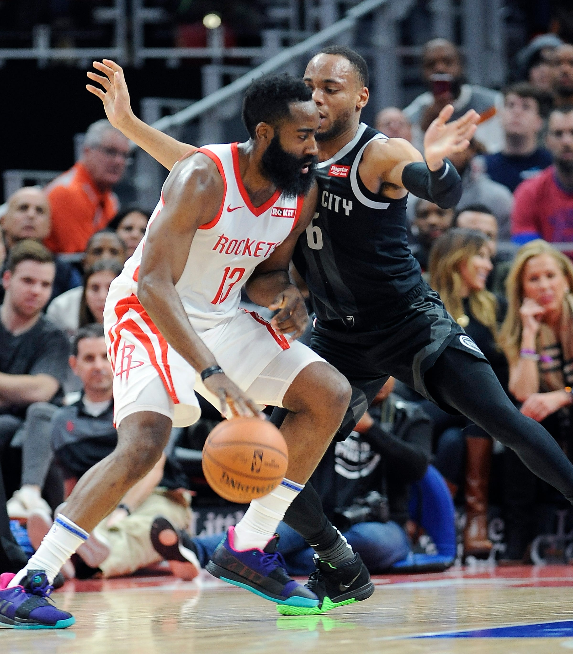 Pistons' Bruce Brown defends Rockets' James Harden in the second quarter.