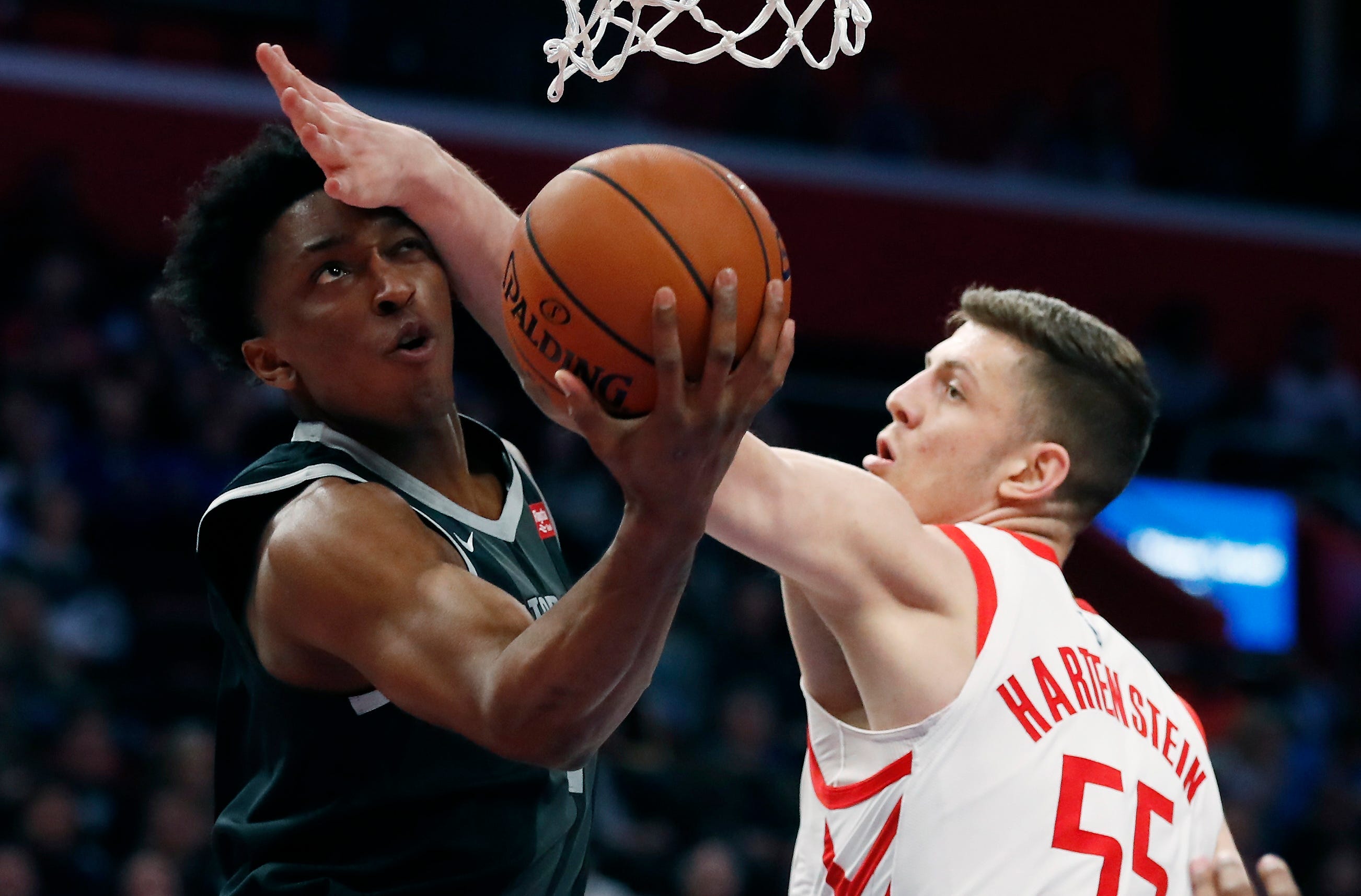 Pistons forward Stanley Johnson makes a layup as Houston Rockets forward Isaiah Hartenstein (55) defends during the first half.