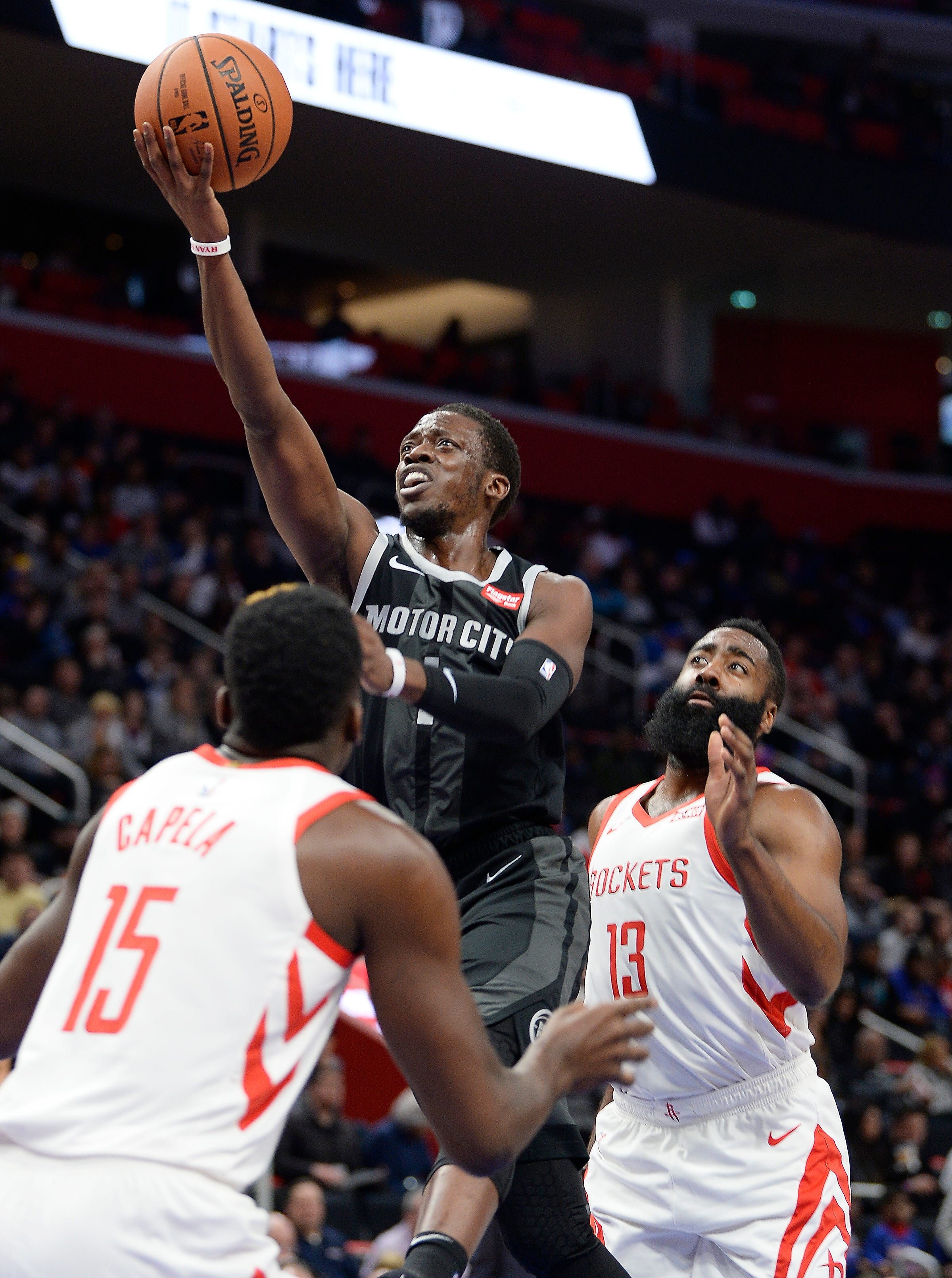 Pistons' Reggie Jackson scores over Rockets' James Harden in the first quarter. Pistons vs Houston Rockets, Little Caesars Arena, November, 23, 2018, Detroit, Mi.