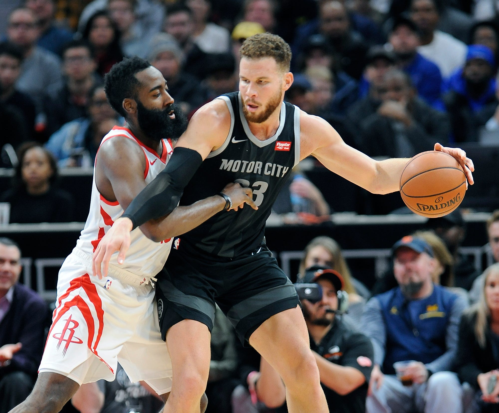 Pistons' Blake Griffin looks for room around Rockets' James Harden in the third quarter.