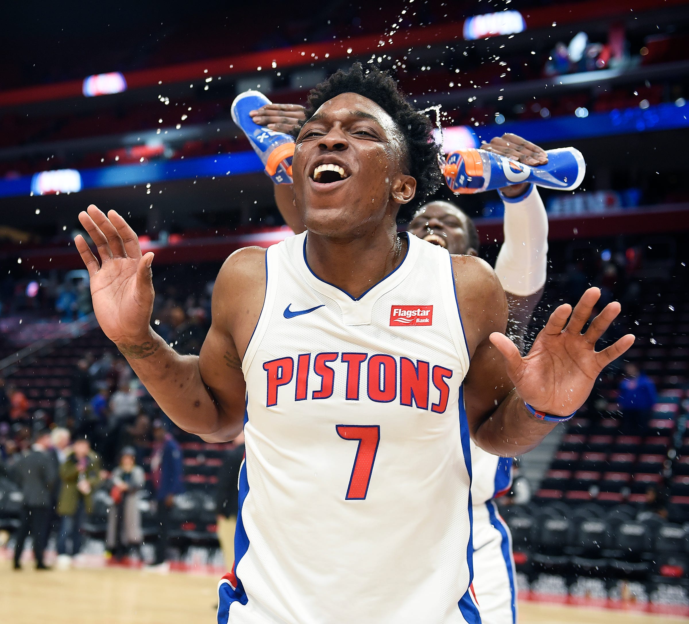 Pistons' Reggie Jackson sprays Stanley Johnson with water during his postgame interview. Johnson had 21 points and 4 rebounds.