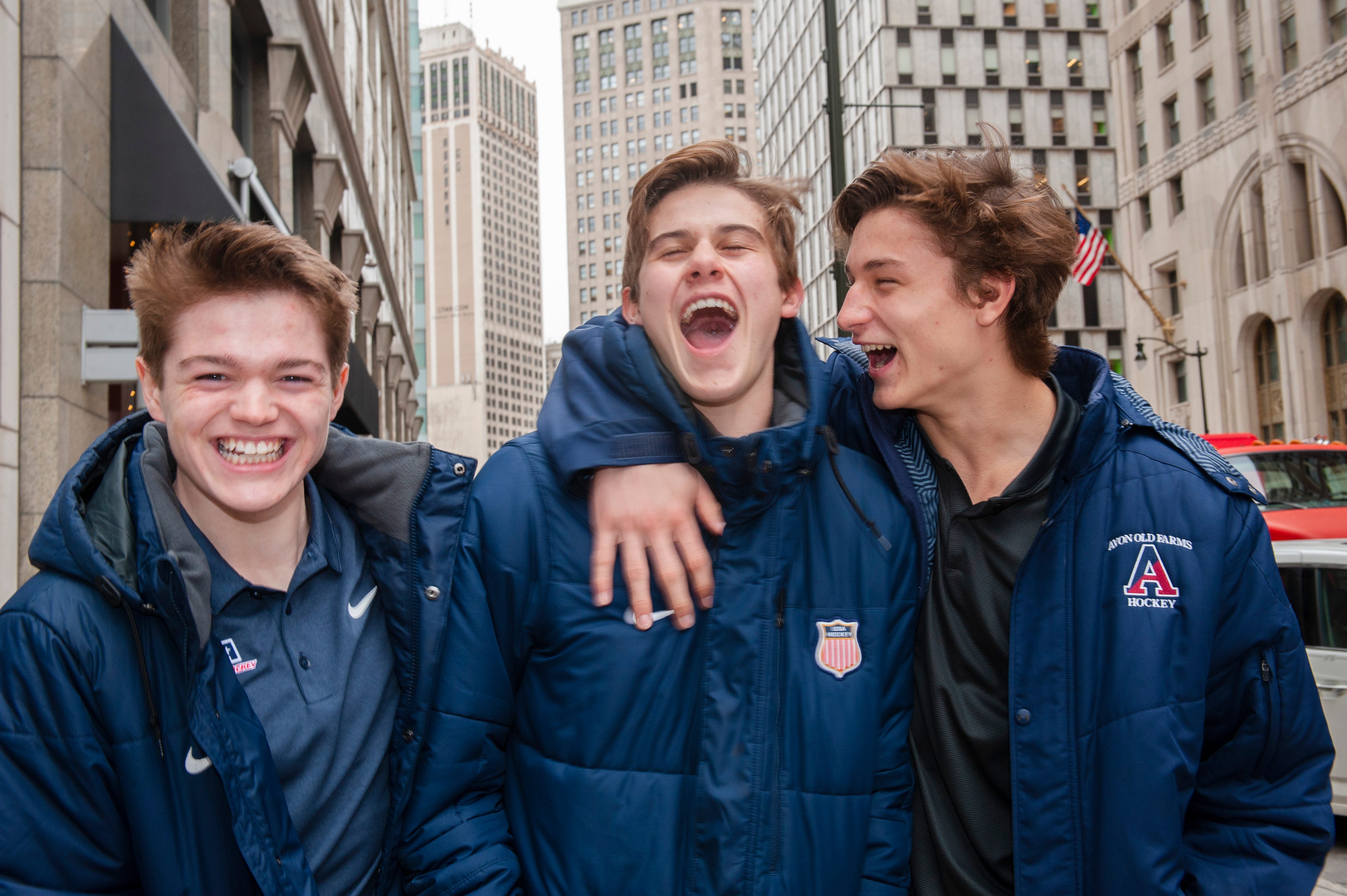 Top-rated NHL draft prospect Jack Hughes, center, jokes around with his linemates Cole Caufield, left, and Trevor Zegras, in downtown Detroit.  They are teammates on the U.S. National Under-18 Team.
