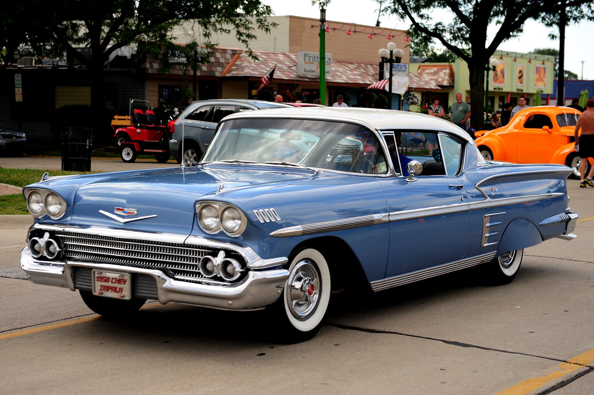 A 1958 Chevy Impala cruises down Woodward in Clawson on Aug. 10, 2013.