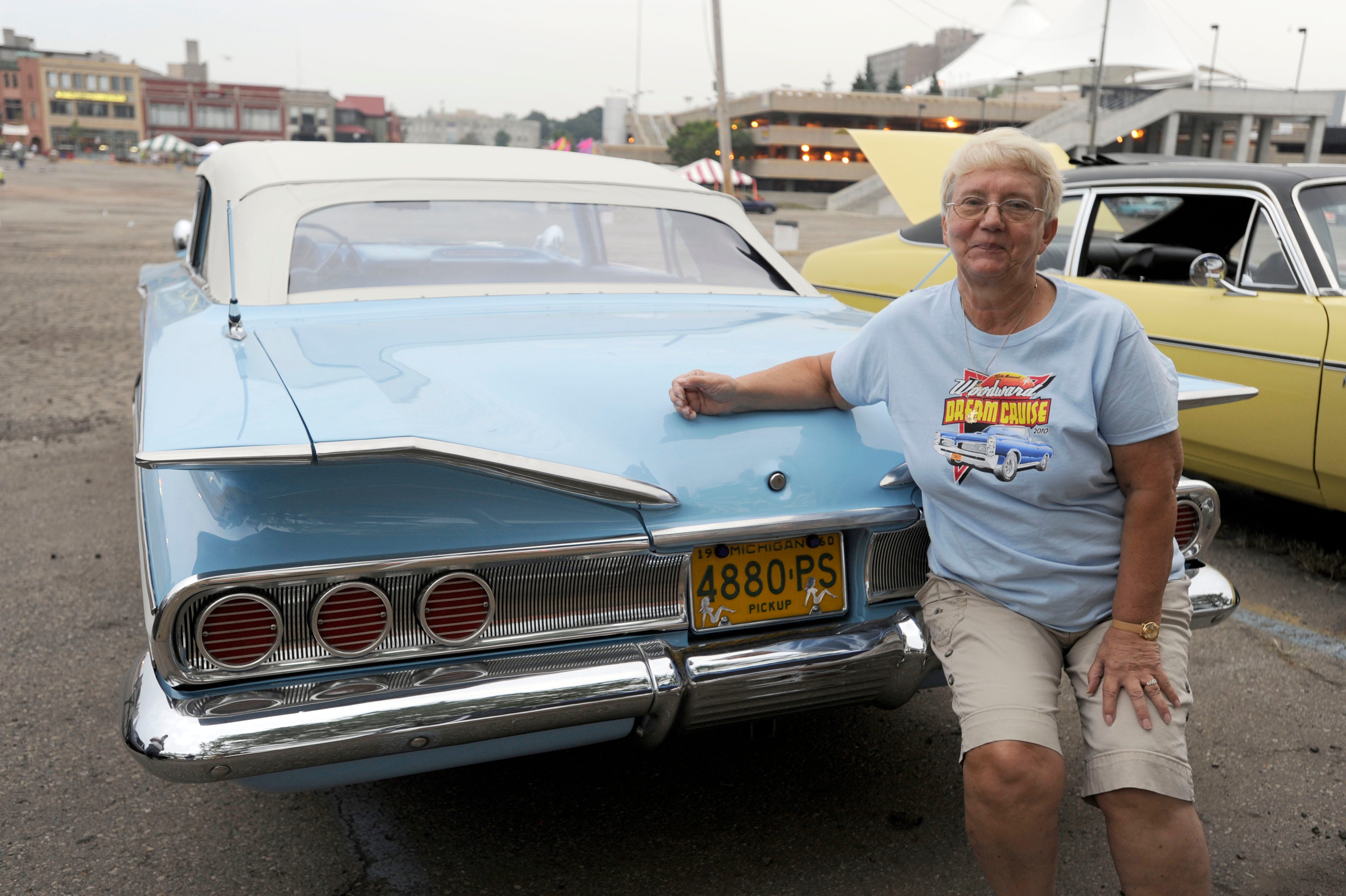 Gay Pousho of White Lake poses with her 1960 Chevrolet Impala Convertiblle in downtown Pontiac.