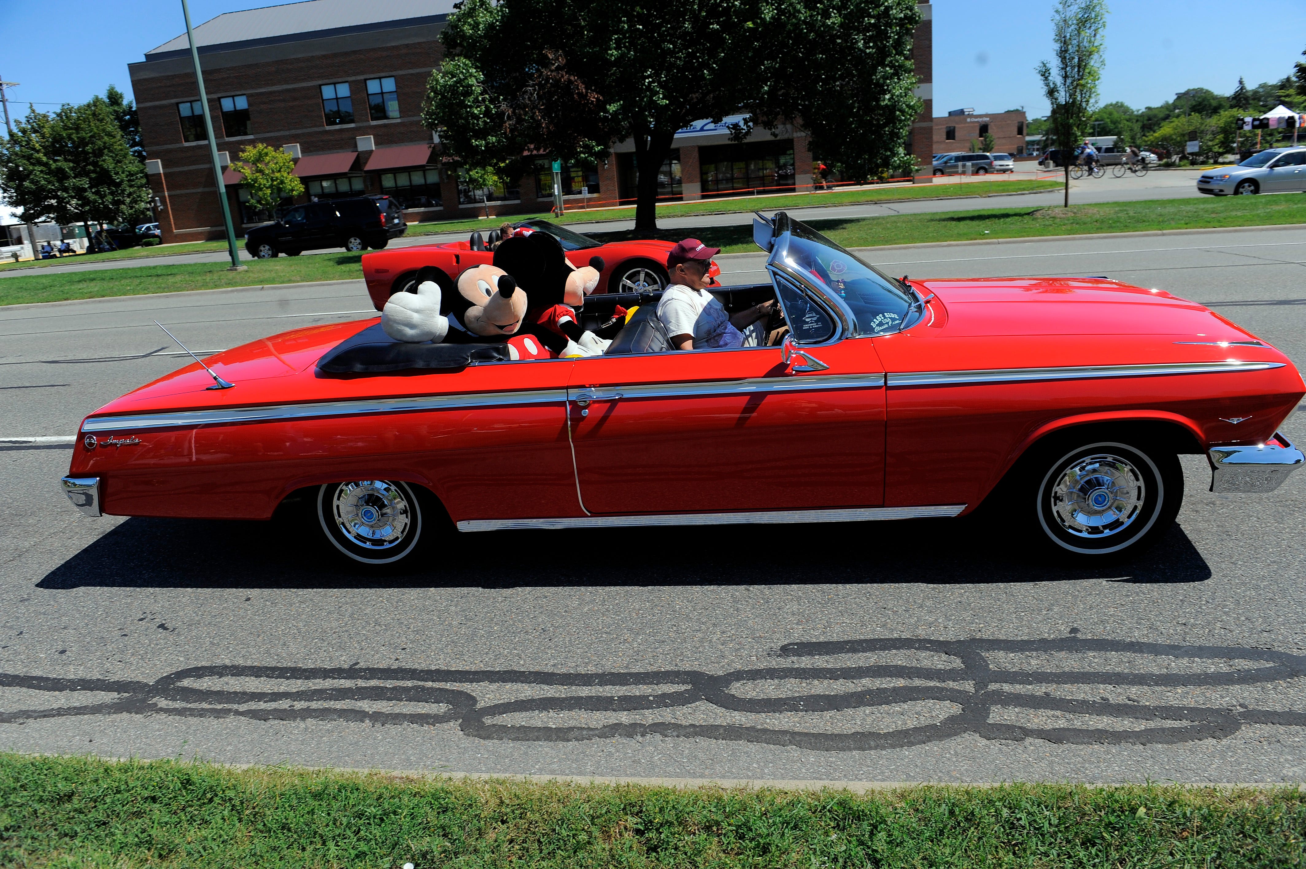A 1963 Chevrolet Impala convertible filled with stuffed animals heads south on Woodward, Friday  Aug. 19, 2011.