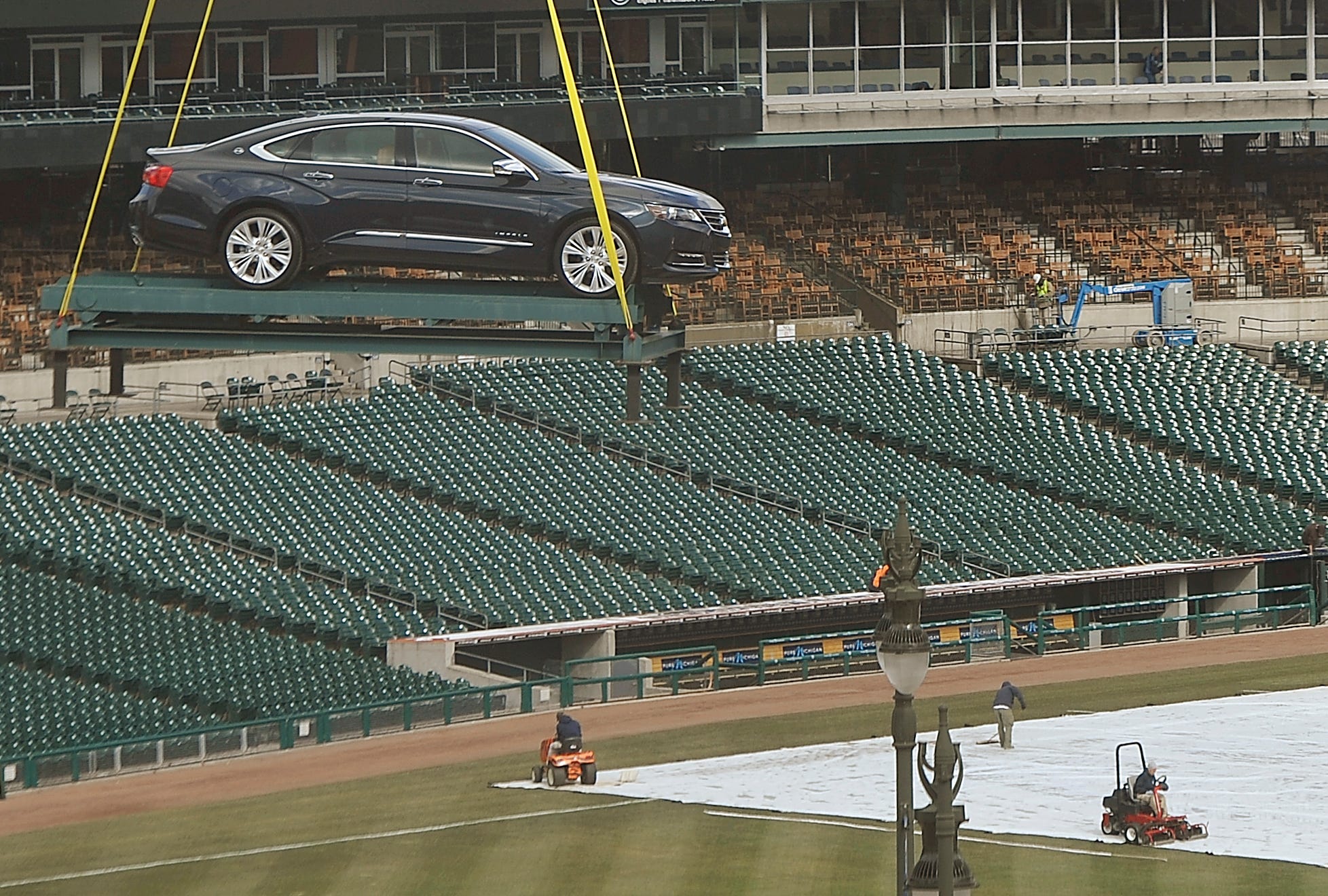 A 2014 Impala is lifted to the top of the Chevrolet fountain at Comerica Park in Detroit on April 1, 2013.
