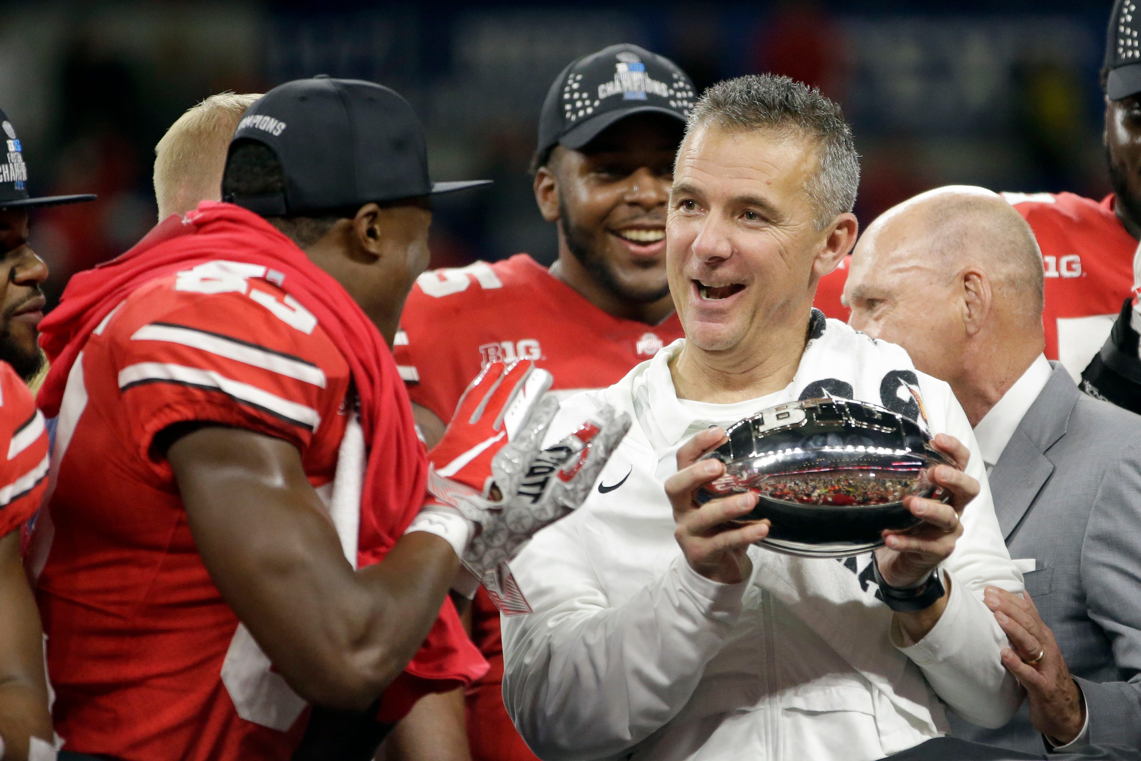 Ohio State head coach Urban Meyer celebrates winning the Big Ten championship. He is retiring after the Rose Bowl.