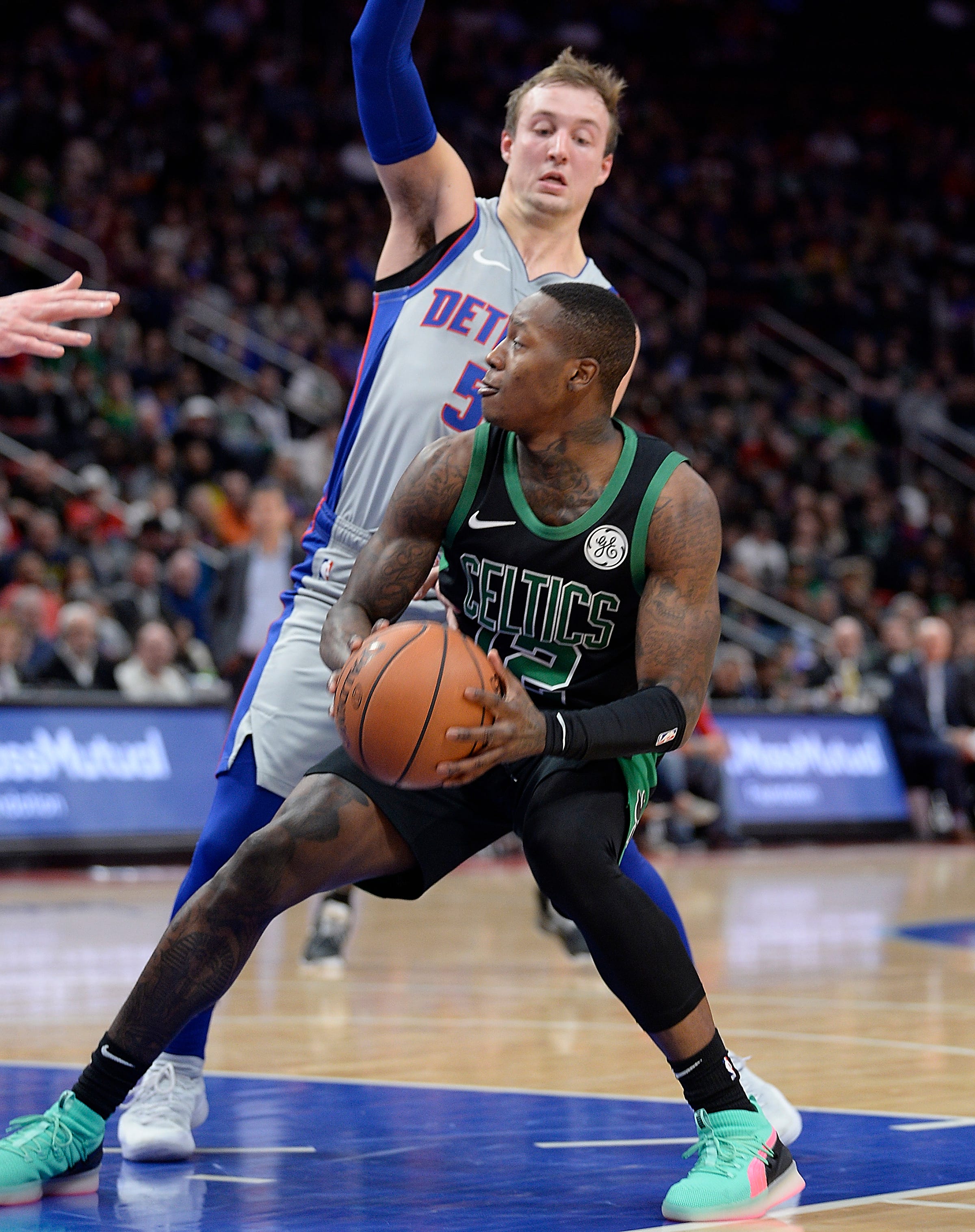 Celtics' Terry Rozier looks for room around Pistons' Luke Kennard in the second quarter.