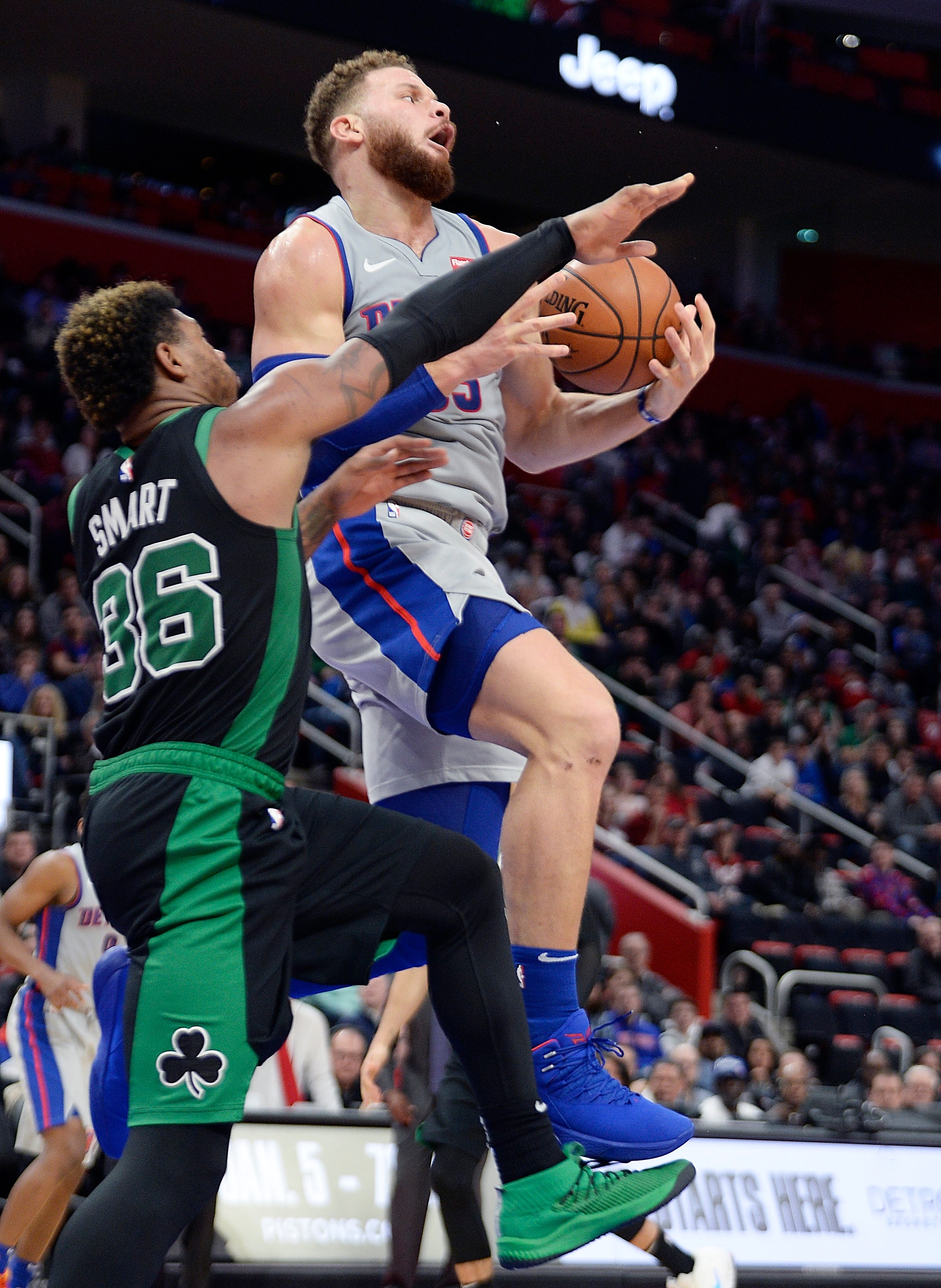 Pistons ' Blake Griffin is fouled by Celtics ' Marcus Smart in the fourth quarter. Griffin had 27 points and eight rebounds.